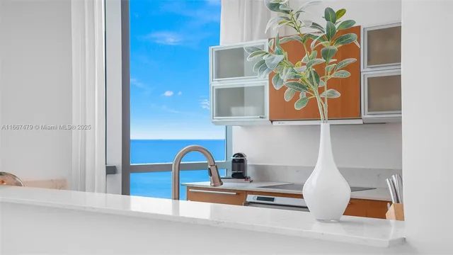 a kitchen with stainless steel appliances granite countertop a sink and a refrigerator