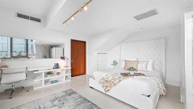 a view of a bathroom with a shower and a mirror