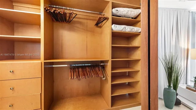 a bedroom with a bed and a potted plant