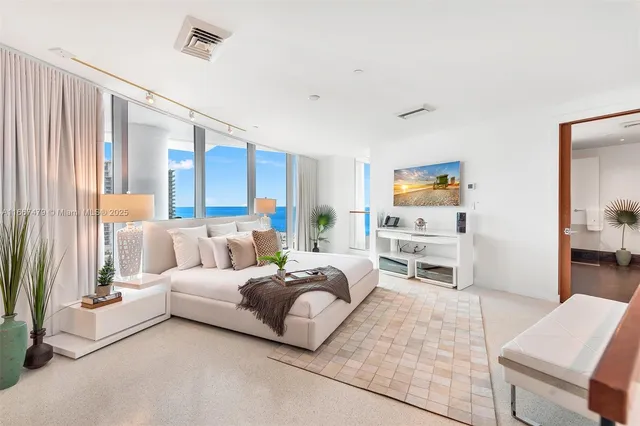 a bedroom with furniture and a flat screen tv