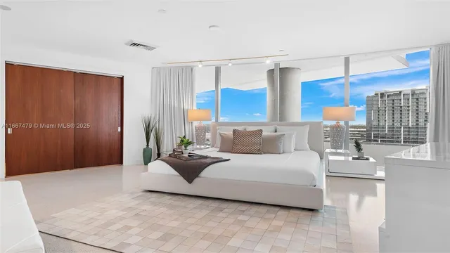 a bed room with furniture and a flat screen tv