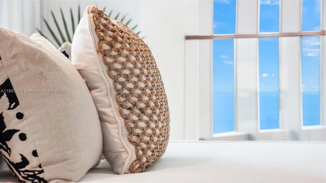 a large white kitchen with a sink and a large mirror