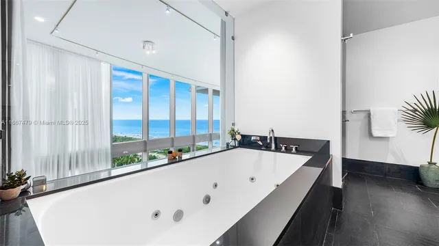 a bathroom with a bathtub and next to a window