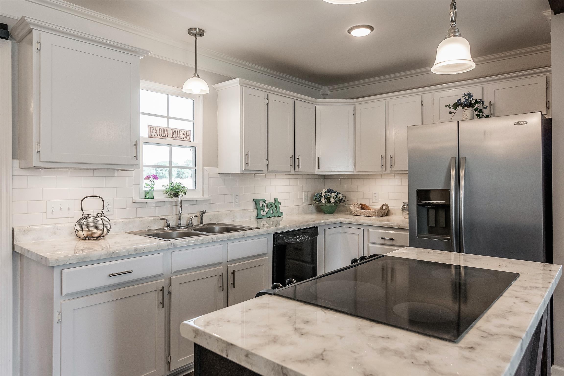 319 Airport Road Portland, TN 37148 - Photo 12 of 29 a kitchen with a sink a center island and cabinets