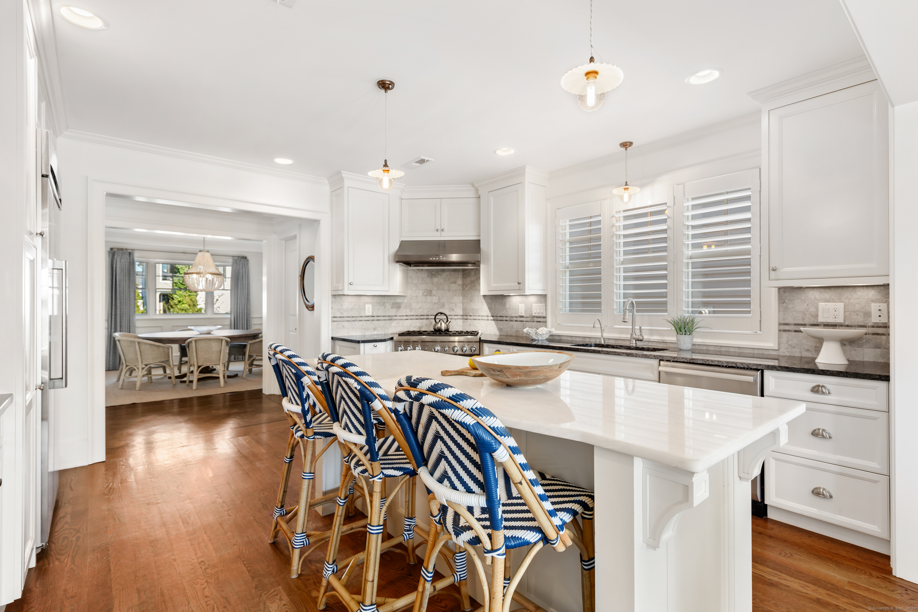 748 Rowland Road Fairfield, CT 06824 - Photo 11 of 38 a kitchen with stainless steel appliances granite countertop a stove a sink dishwasher and a refrigerator with wooden floor