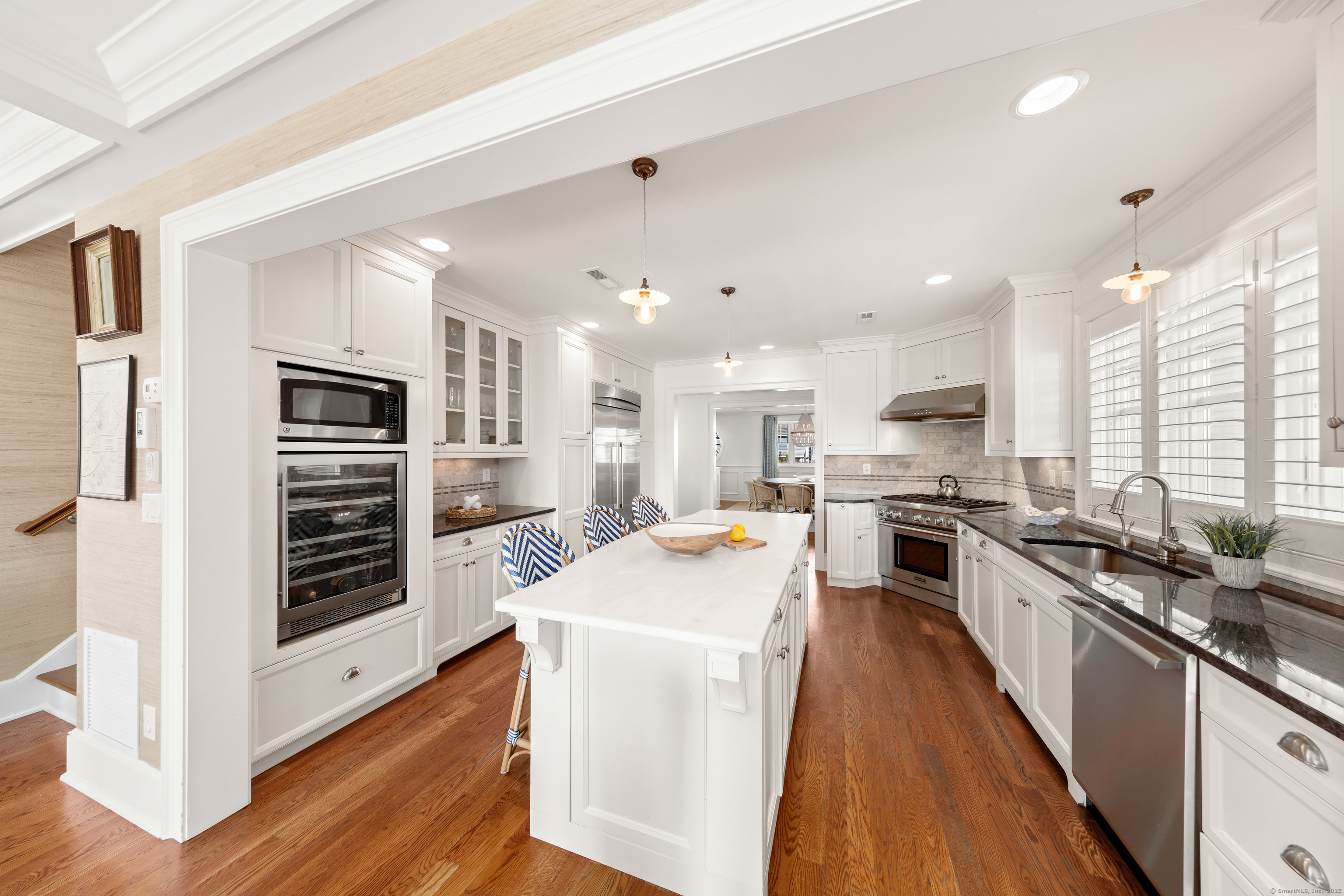 748 Rowland Road Fairfield, CT 06824 - Photo 12 of 38 a large kitchen with stainless steel appliances lots of counter space and wooden floor
