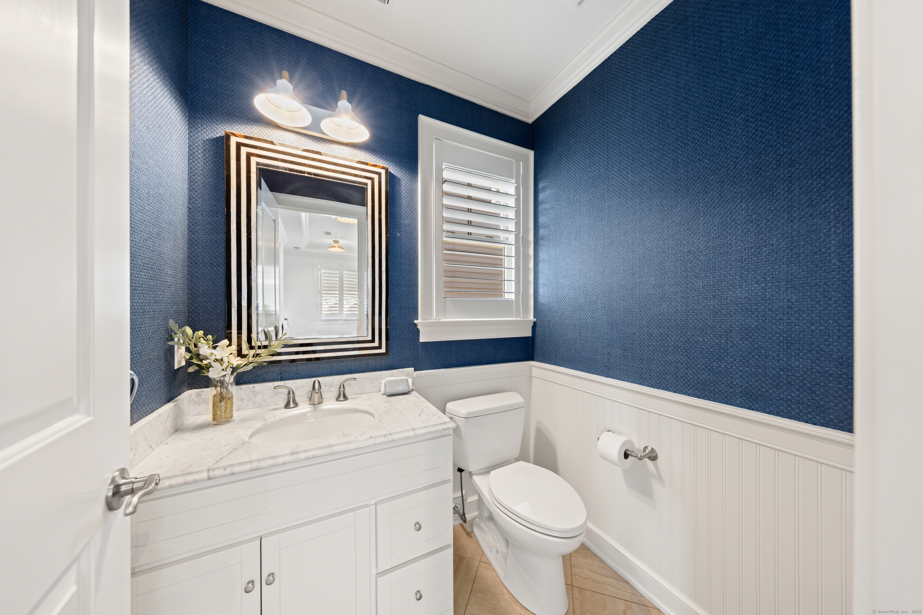 748 Rowland Road Fairfield, CT 06824 - Photo 13 of 38 a bathroom with a sink a toilet and mirror