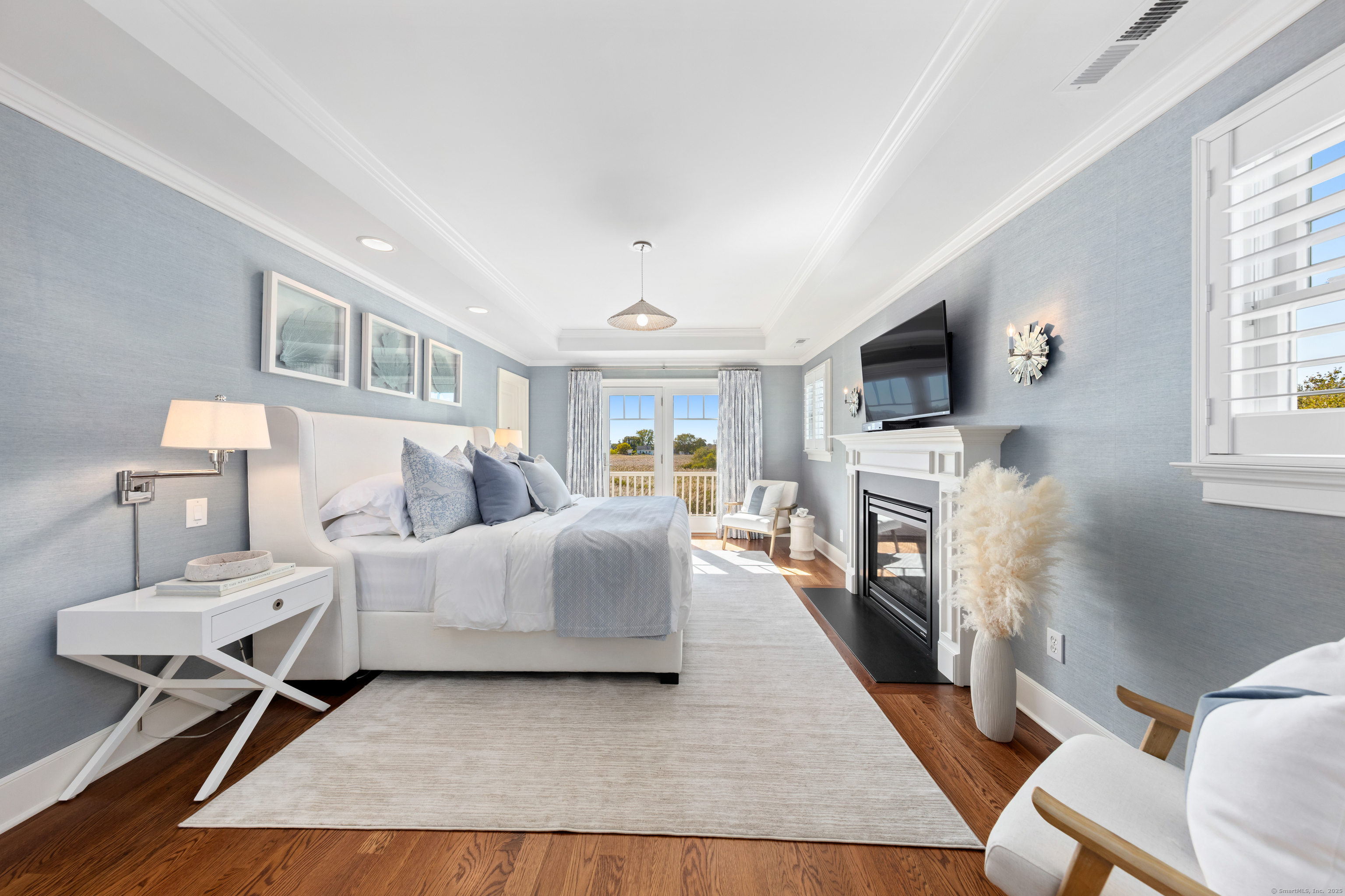 748 Rowland Road Fairfield, CT 06824 - Photo 15 of 38 a living room with furniture a fireplace and a flat screen tv