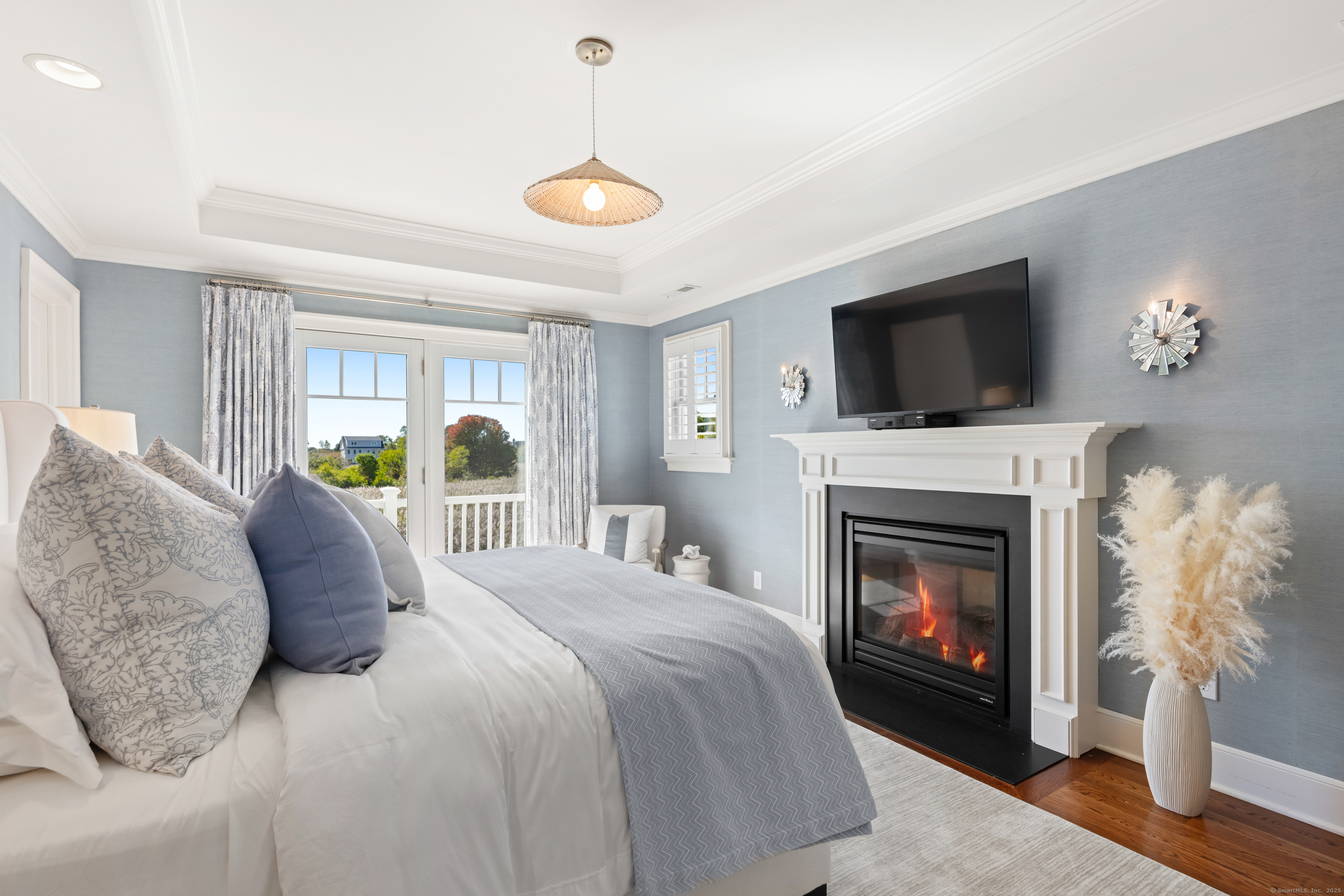 748 Rowland Road Fairfield, CT 06824 - Photo 16 of 38 a bed room with a balcony a bed and a fireplace