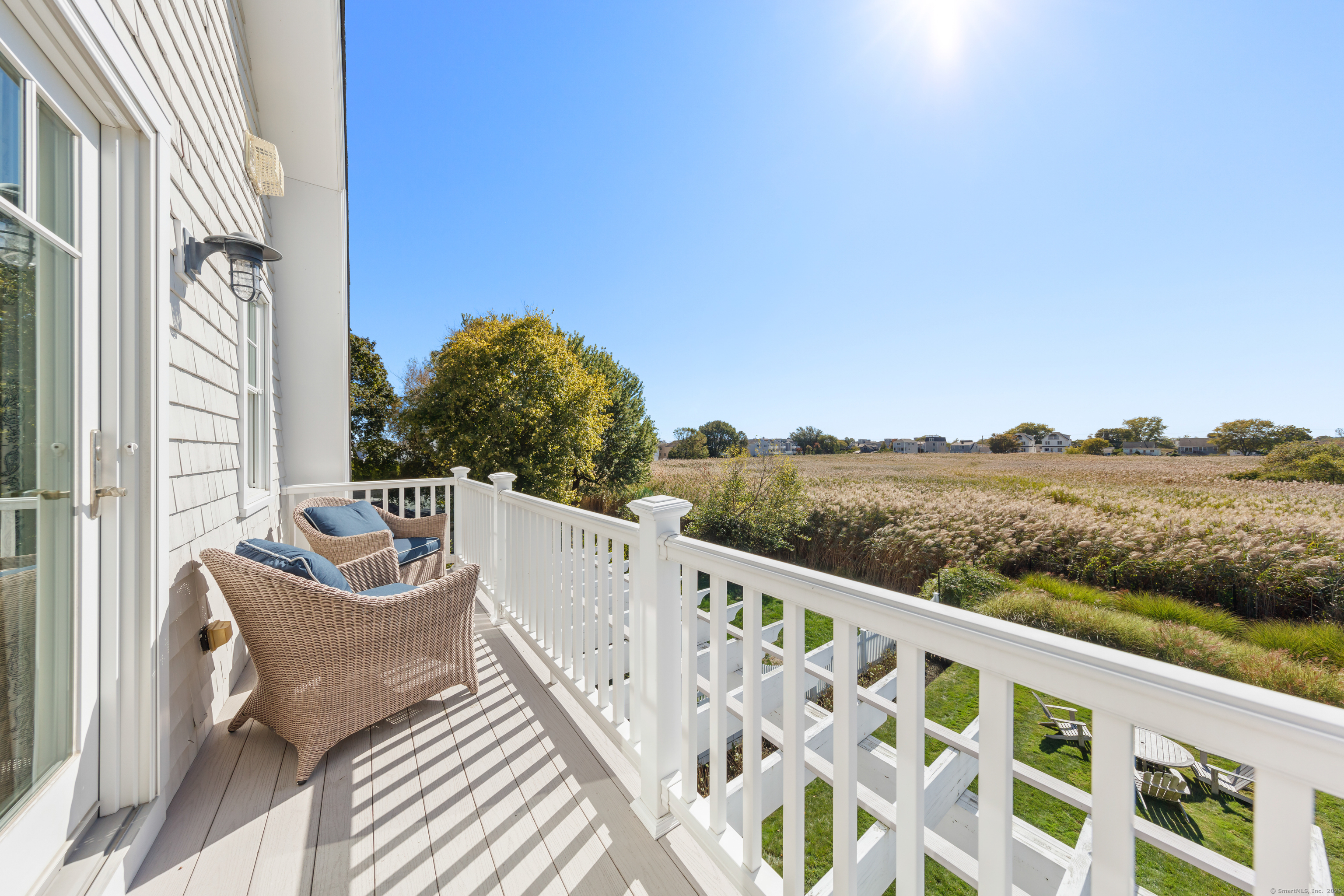 748 Rowland Road Fairfield, CT 06824 - Photo 17 of 38 a view of a balcony with wooden floor and fence