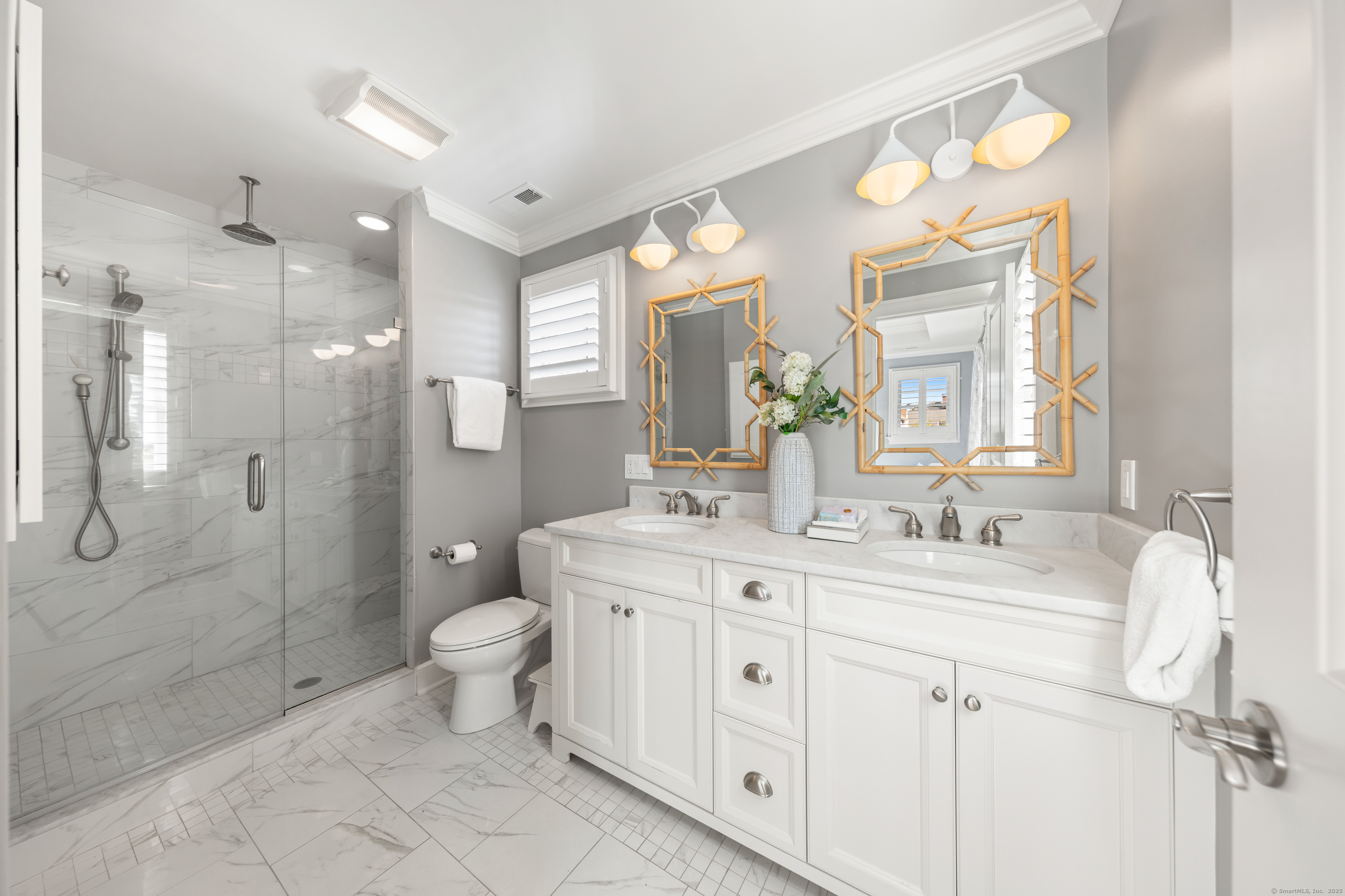 748 Rowland Road Fairfield, CT 06824 - Photo 18 of 38 a spacious bathroom with a double vanity sink toilet mirror and shower