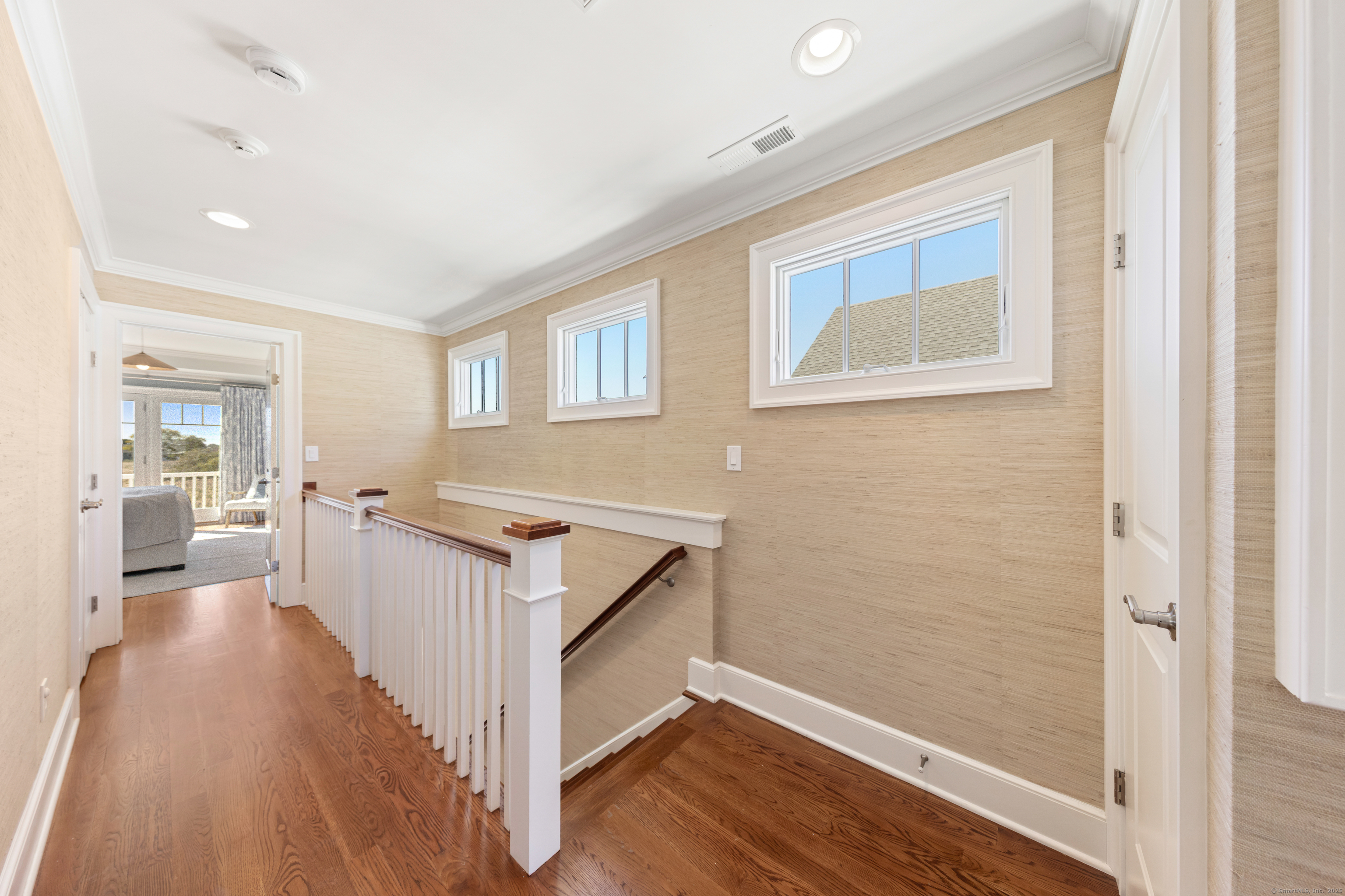 748 Rowland Road Fairfield, CT 06824 - Photo 24 of 38 a view of a hallway with wooden floor and staircase