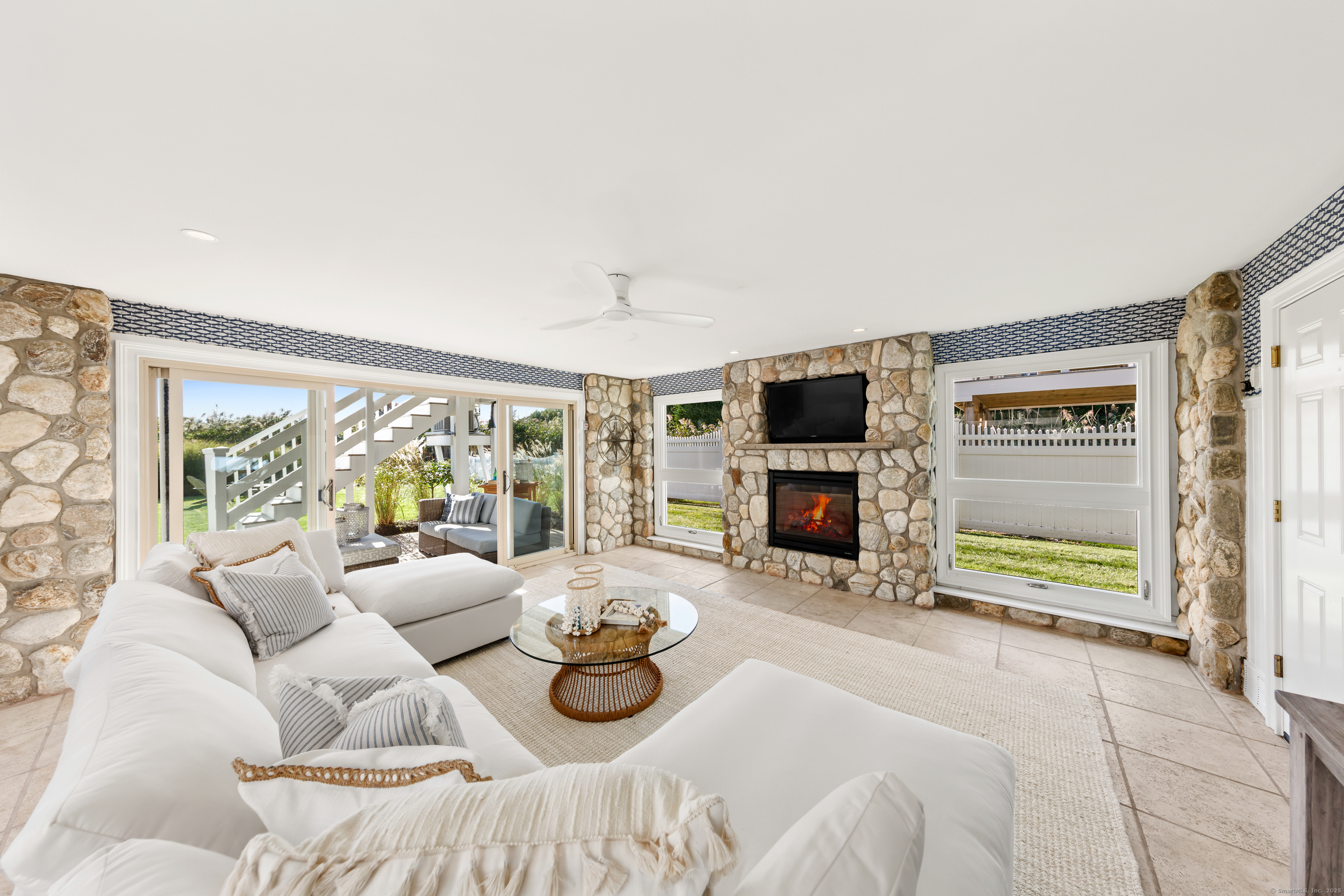 748 Rowland Road Fairfield, CT 06824 - Photo 26 of 38 a bedroom with furniture and a fireplace