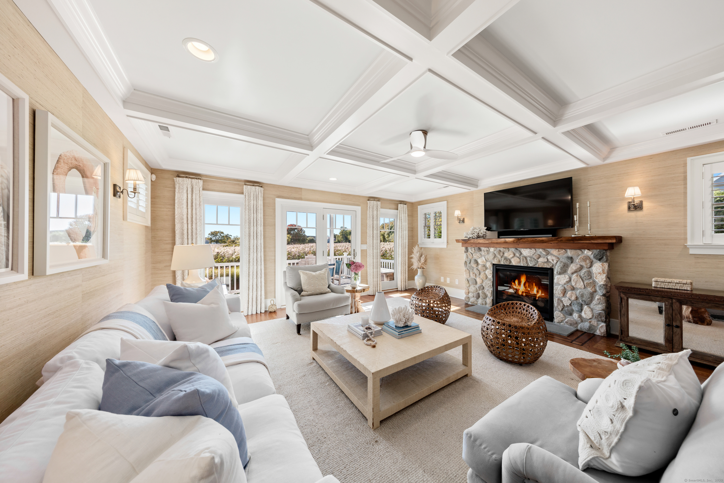 748 Rowland Road Fairfield, CT 06824 - Photo 4 of 38 a living room with furniture fireplace and a flat screen tv