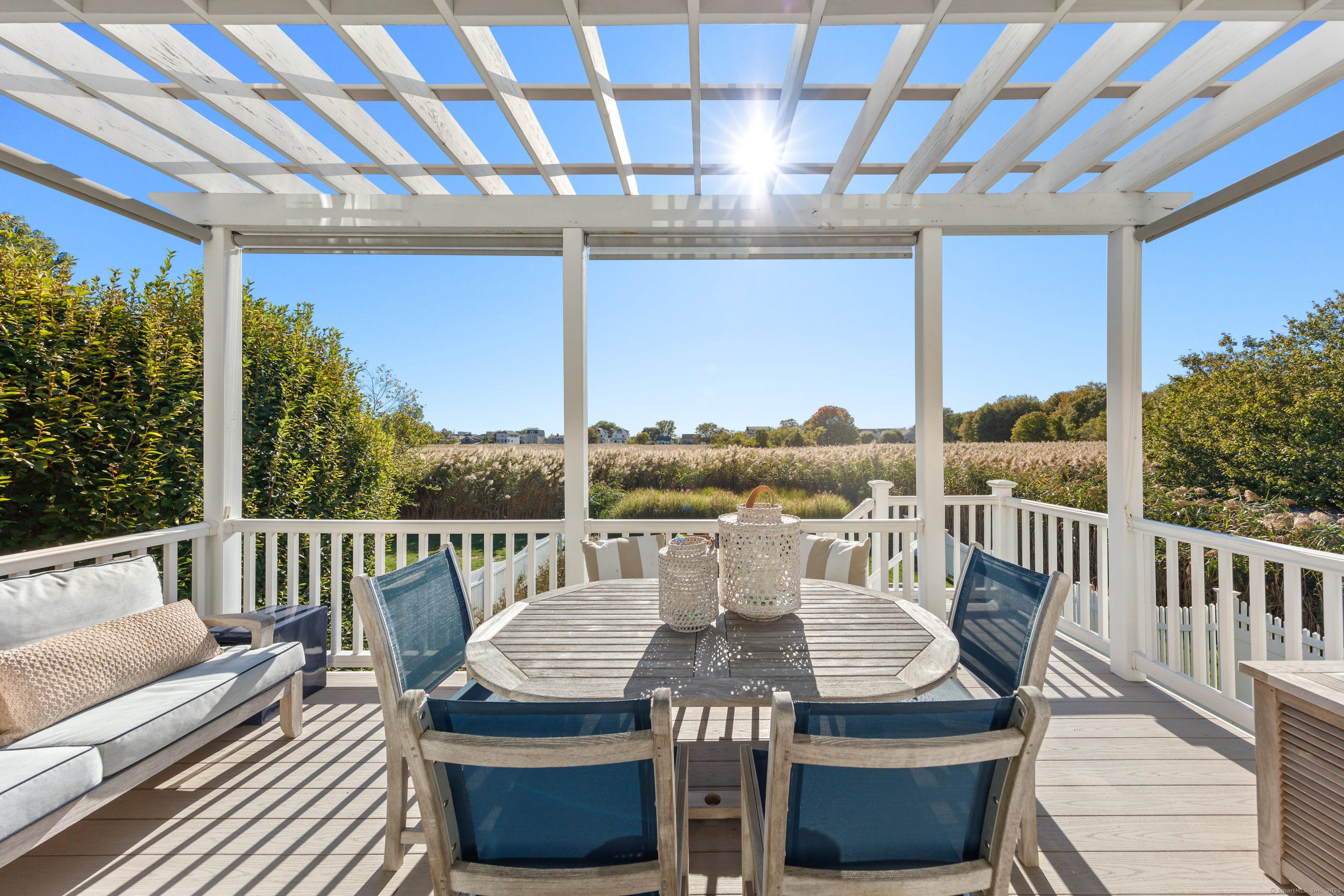 748 Rowland Road Fairfield, CT 06824 - Photo 6 of 38 a view of a patio with a table chairs and a patio