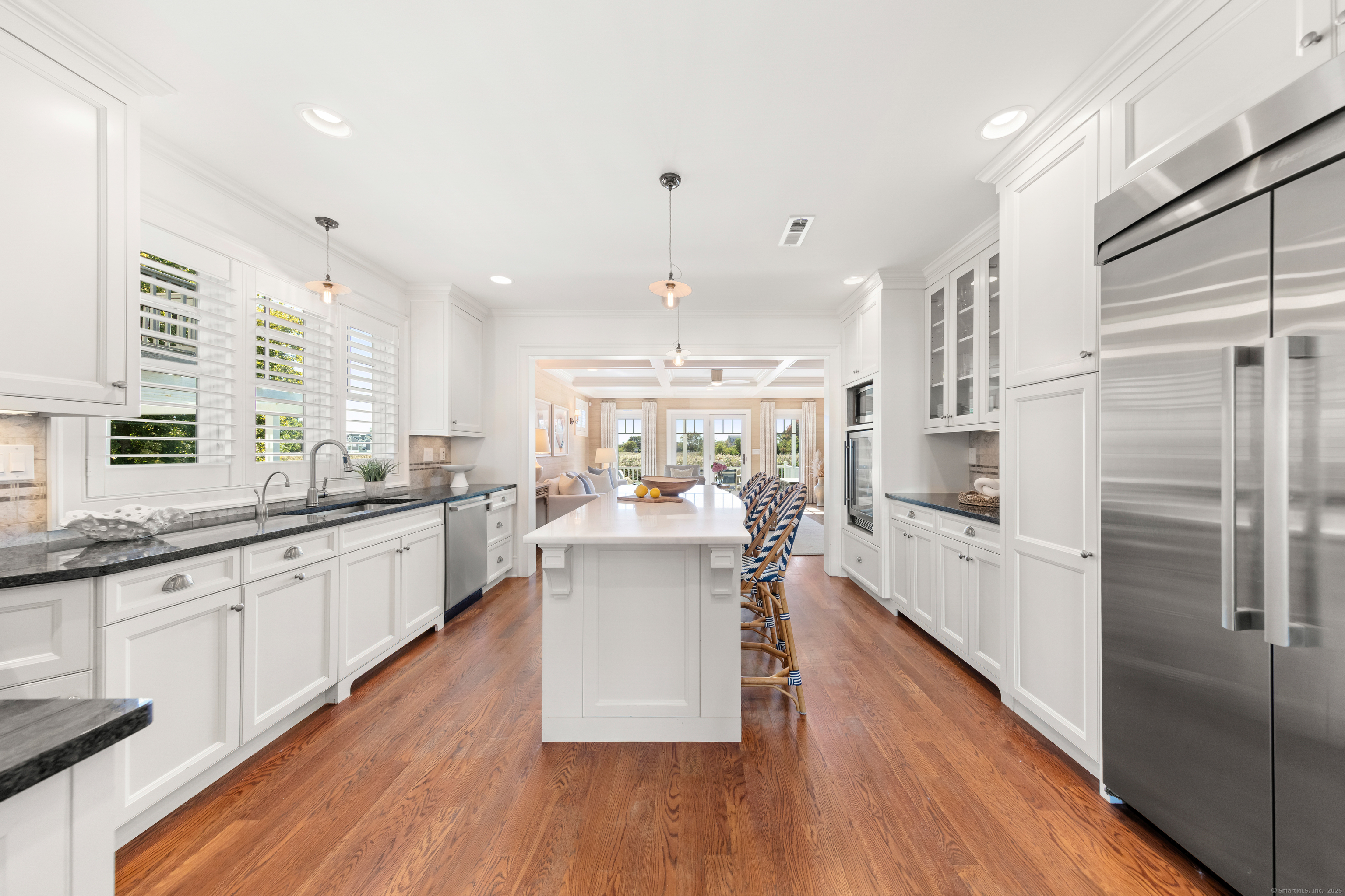 748 Rowland Road Fairfield, CT 06824 - Photo 10 of 38 a large kitchen with cabinets wooden floor and stainless steel appliances