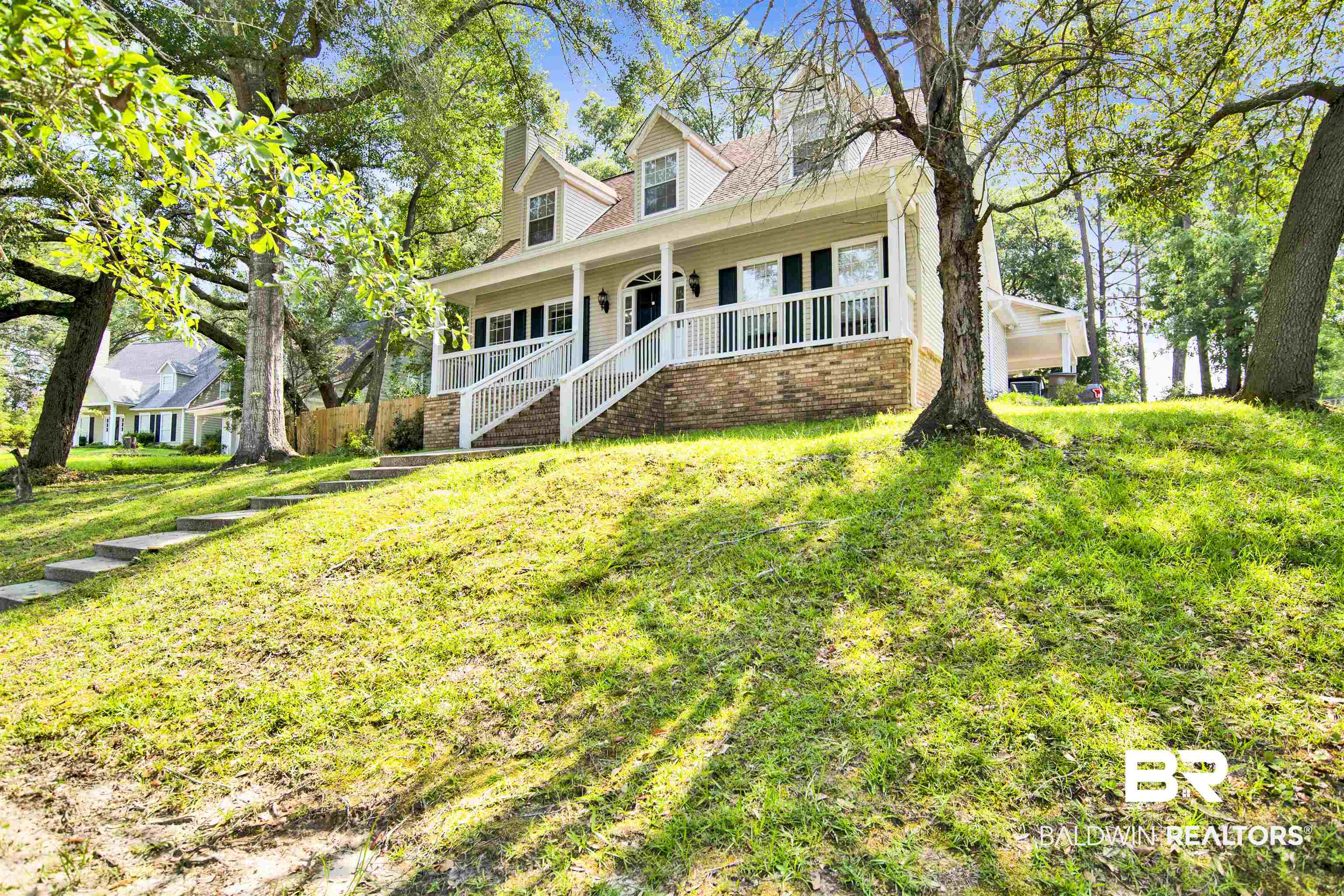 3412 Peyton Court Mobile, AL 36695 - Photo 3 of 27 Cape cod house with a porch, stairs, a chimney, and a front lawn