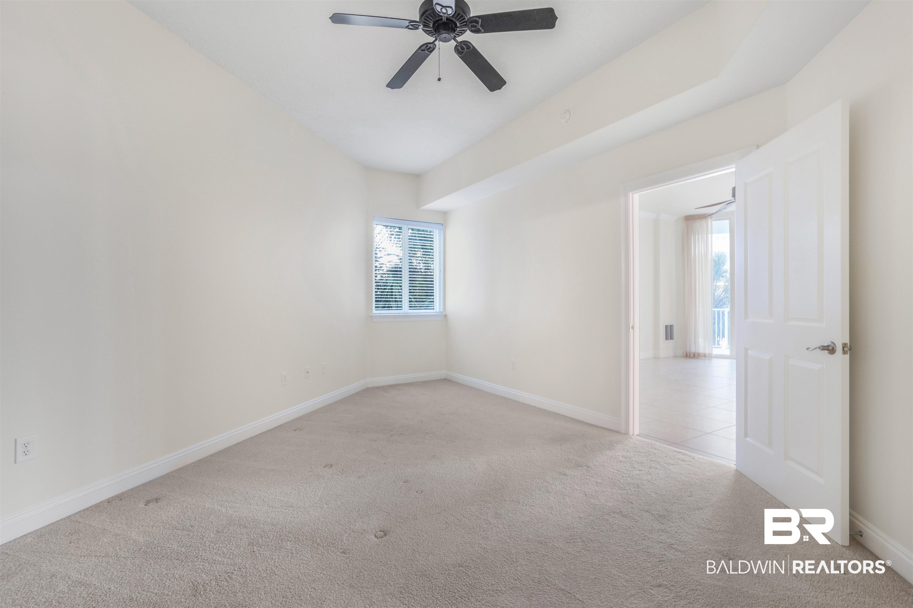 28250 Canal Road, Unit 106 Orange Beach, AL 36561 - Photo 19 of 50 Spare room featuring light colored carpet and ceiling fan