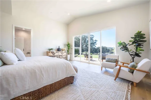 a bedroom with a large bed and a large window