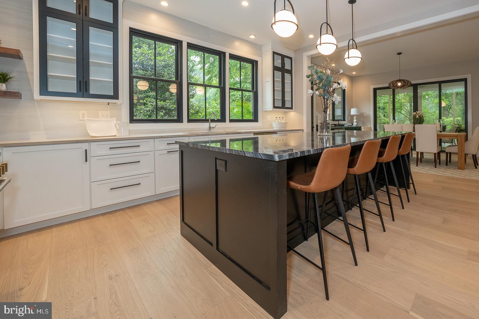 187 South Spring Mill Road Villanova, PA 19085 - Photo 14 of 53 a kitchen with kitchen island a large window in it and dining table