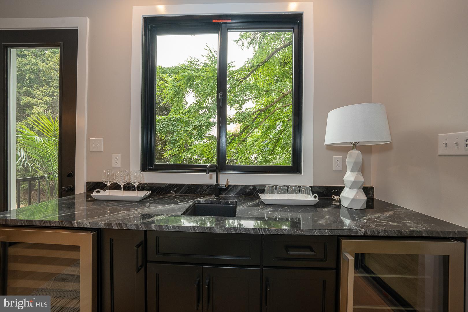 187 South Spring Mill Road Villanova, PA 19085 - Photo 16 of 53 a kitchen with granite countertop a stove a sink and a window