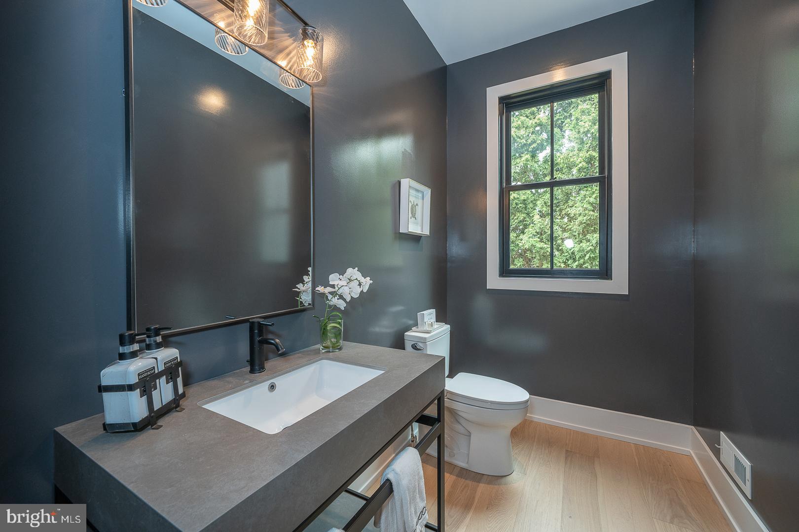 187 South Spring Mill Road Villanova, PA 19085 - Photo 20 of 53 a bathroom with a granite countertop sink a toilet and a mirror