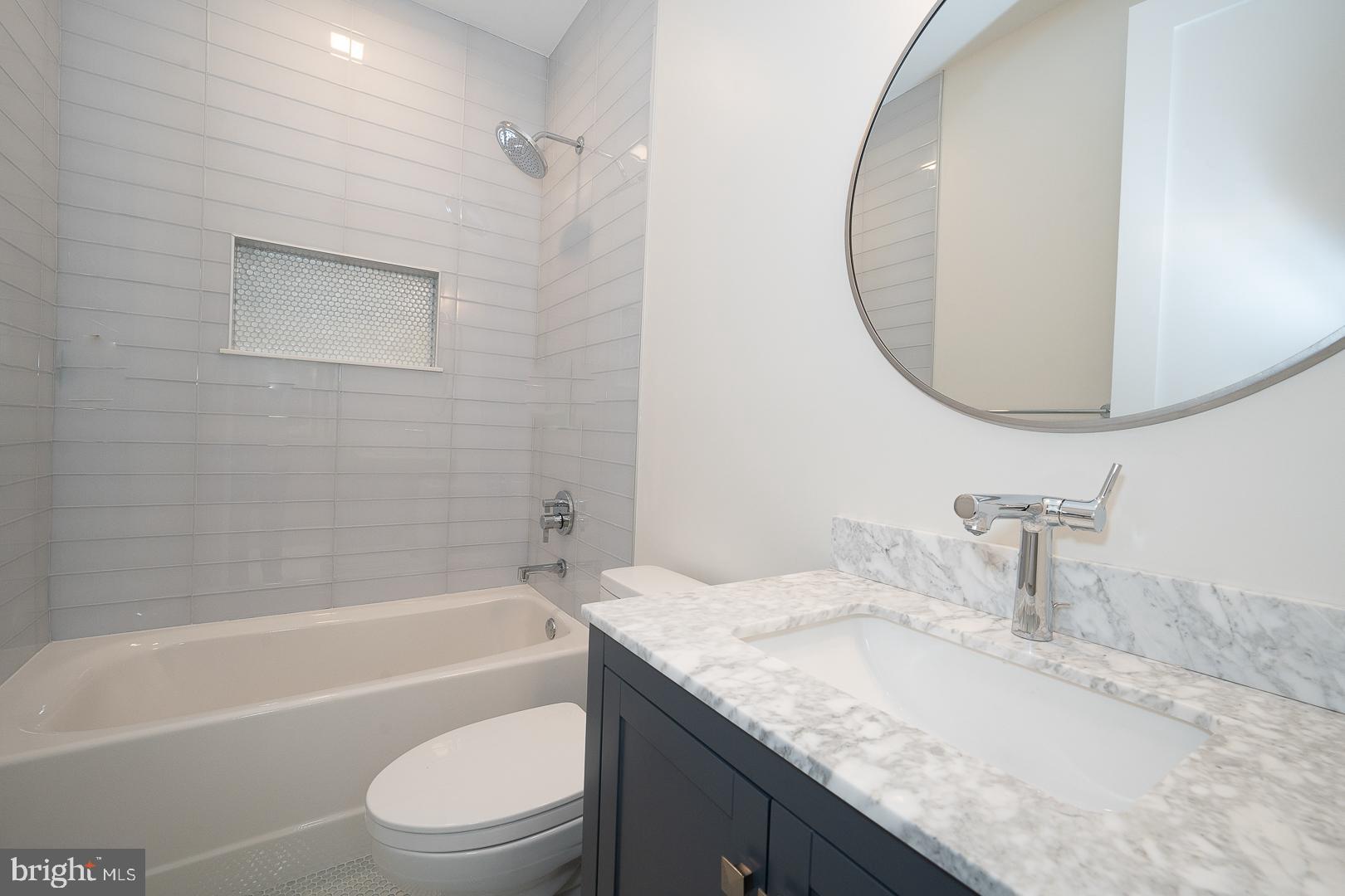 187 South Spring Mill Road Villanova, PA 19085 - Photo 37 of 53 a bathroom with a granite countertop sink a toilet and bathtub