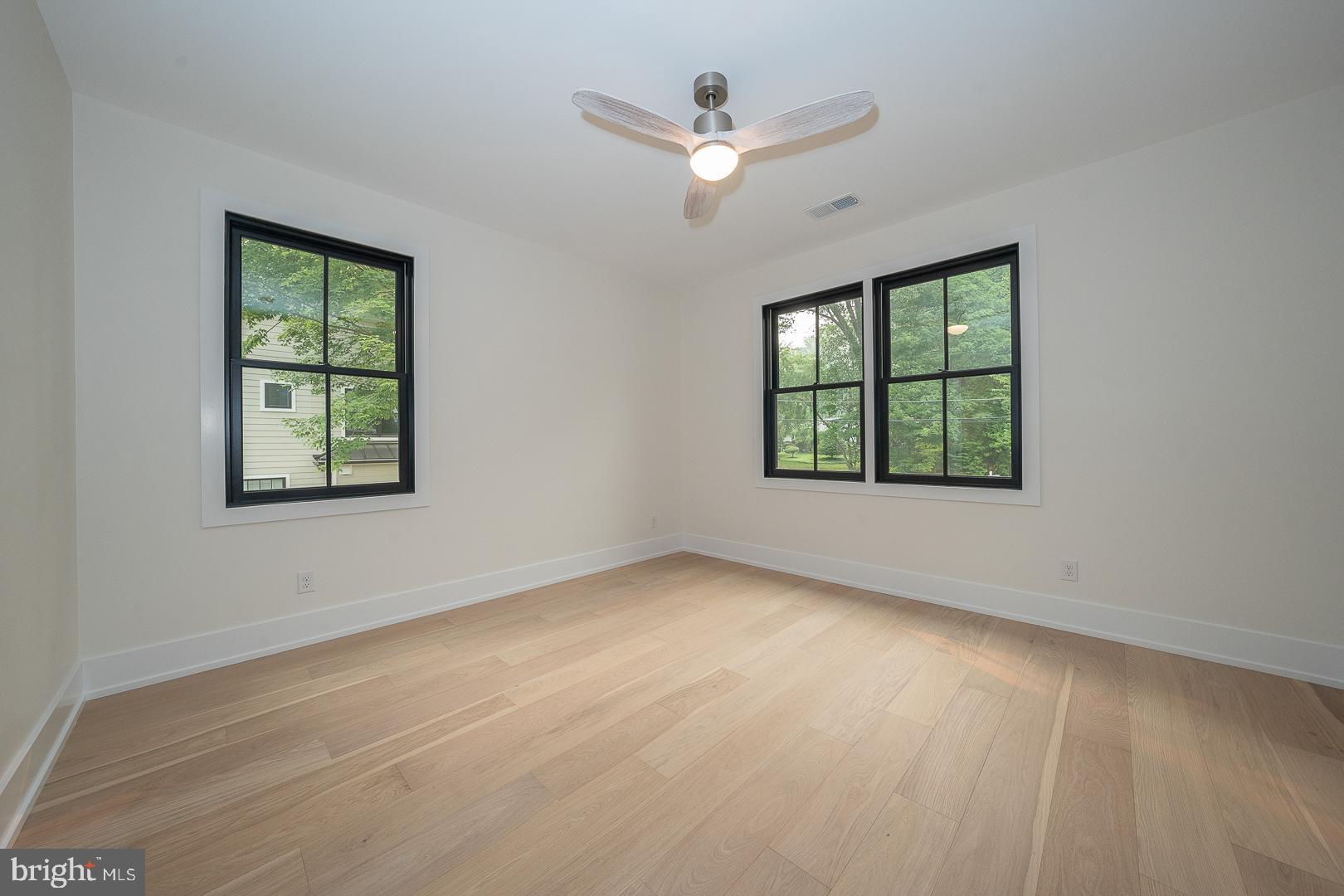187 South Spring Mill Road Villanova, PA 19085 - Photo 41 of 53 an empty room with windows and ceiling fan