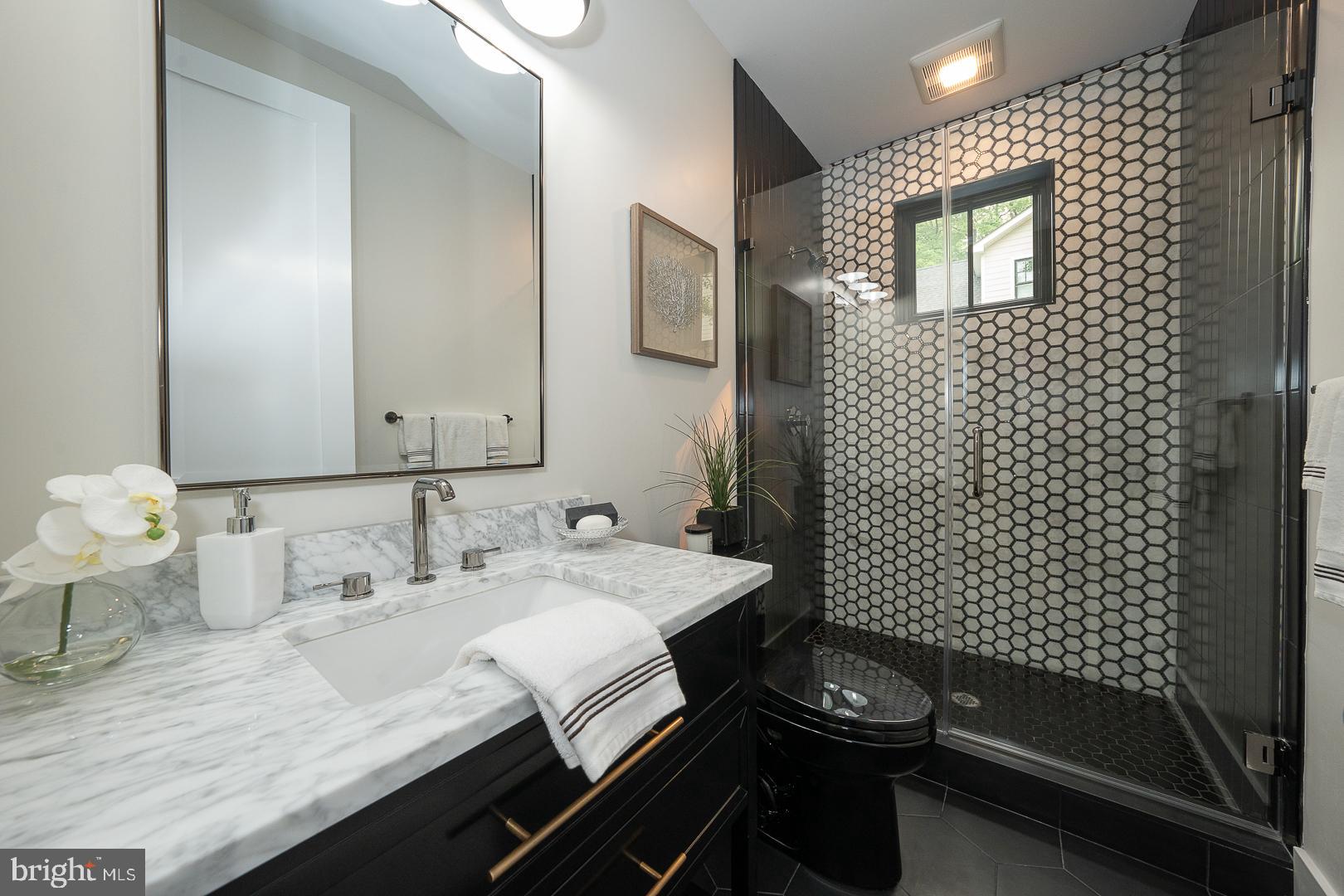 187 South Spring Mill Road Villanova, PA 19085 - Photo 7 of 53 a bathroom with a sink and a mirror