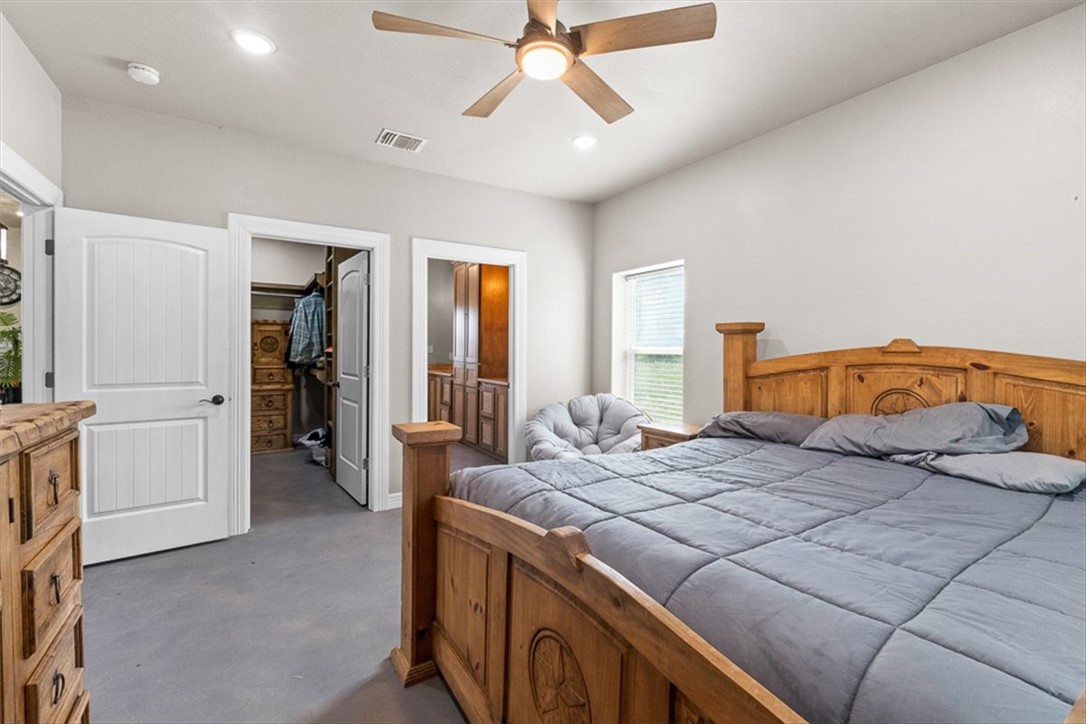 207 South Charles Street George West, TX 78022 - Photo 21 of 24 a bedroom with a bed and a chandelier