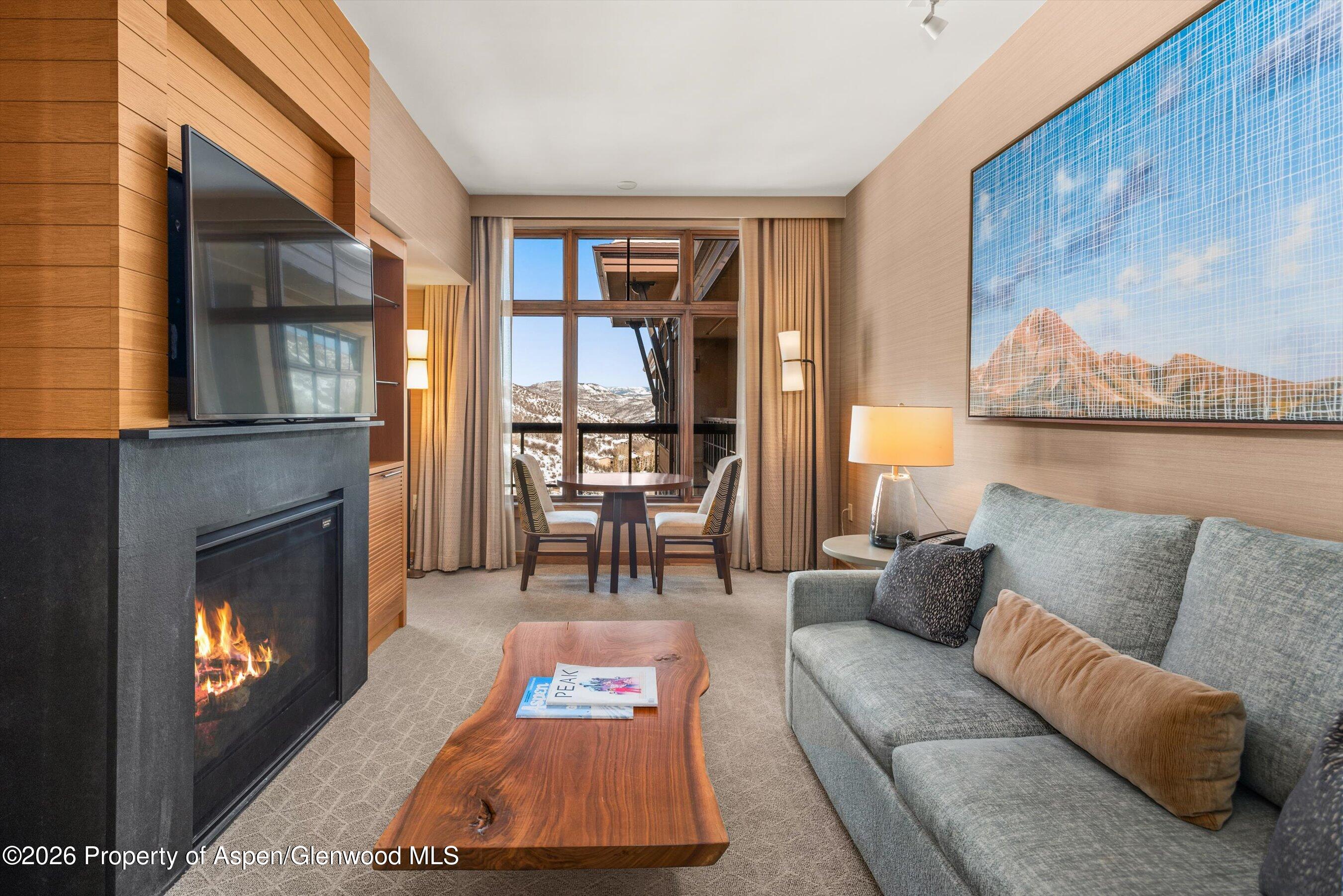 130 Wood Road, Unit 716 Snowmass Village, CO 81615 - Photo 2 of 12 a living room with furniture and a fireplace