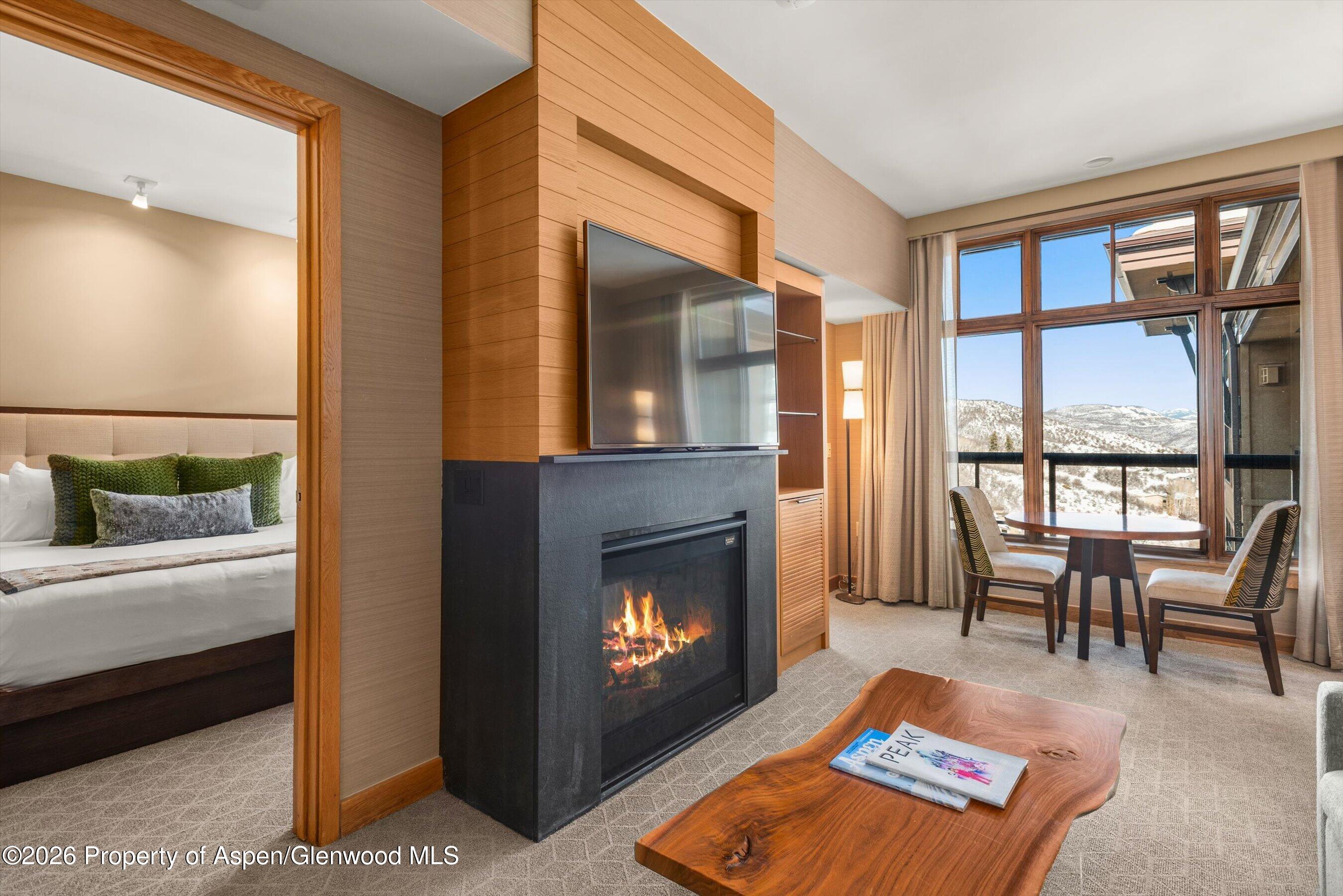130 Wood Road, Unit 716 Snowmass Village, CO 81615 - Photo 3 of 12 a living room with furniture and a fireplace