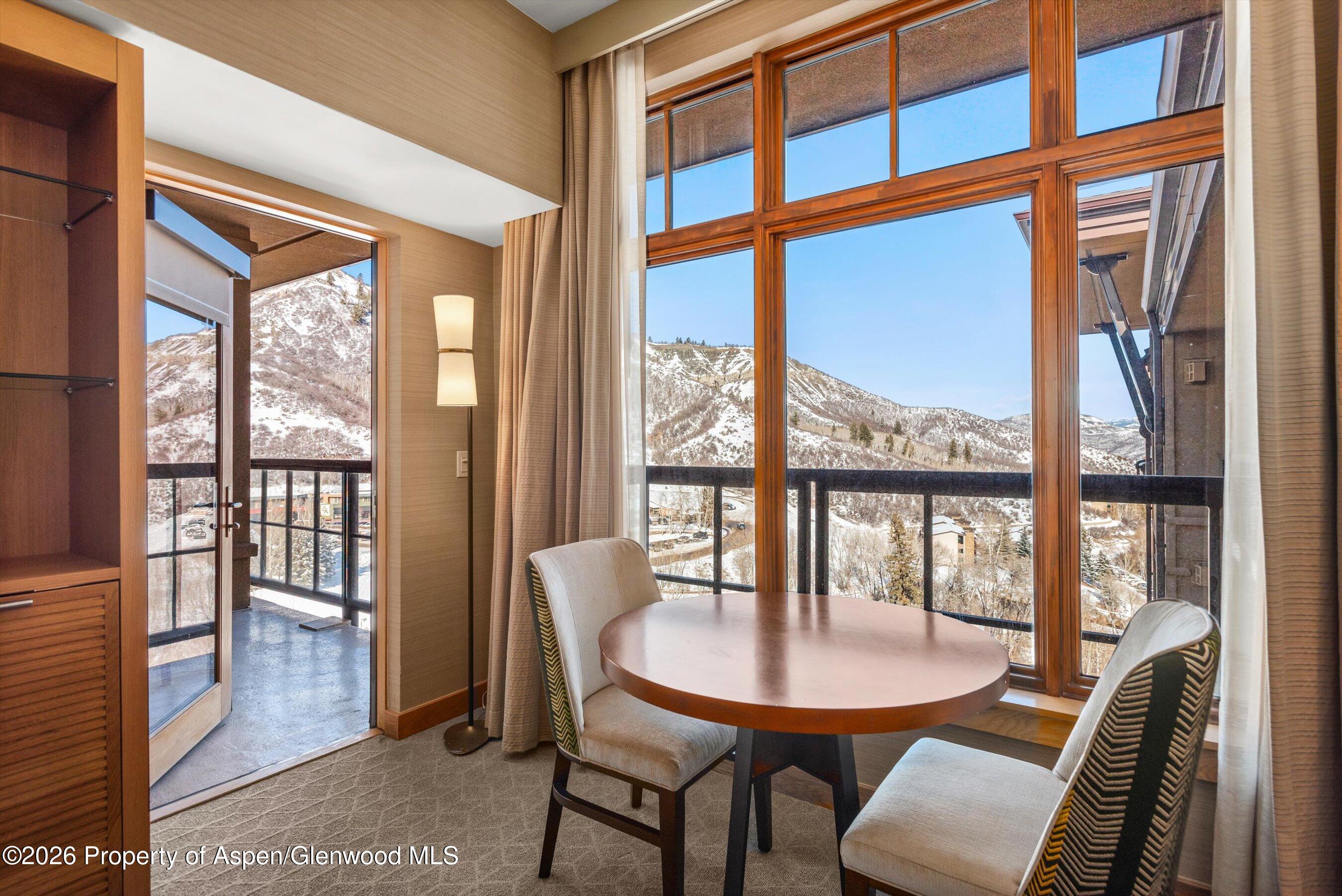 130 Wood Road, Unit 716 Snowmass Village, CO 81615 - Photo 4 of 12 a view of a dining room with furniture window and wooden floor