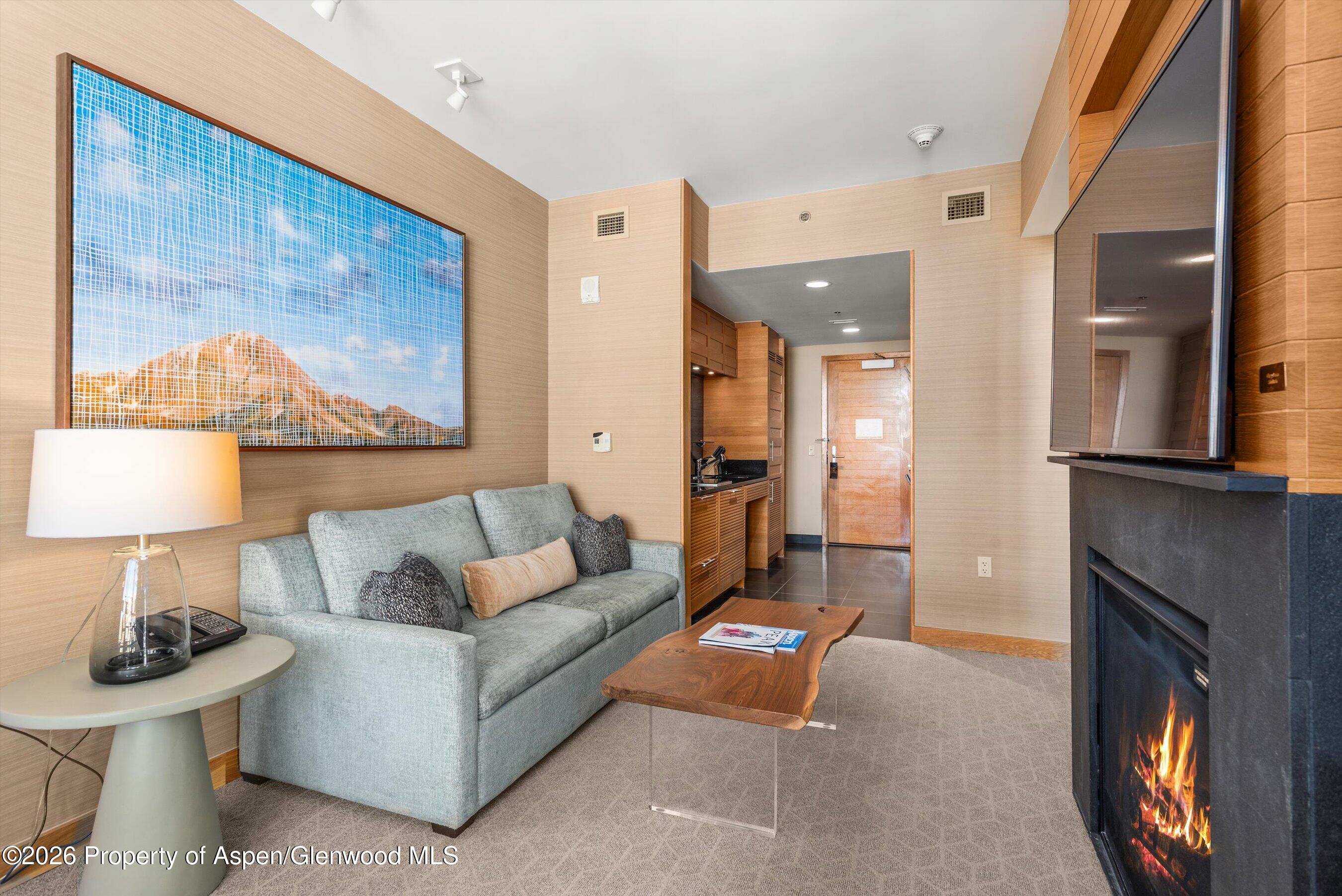 130 Wood Road, Unit 716 Snowmass Village, CO 81615 - Photo 6 of 12 a living room with furniture and a fireplace