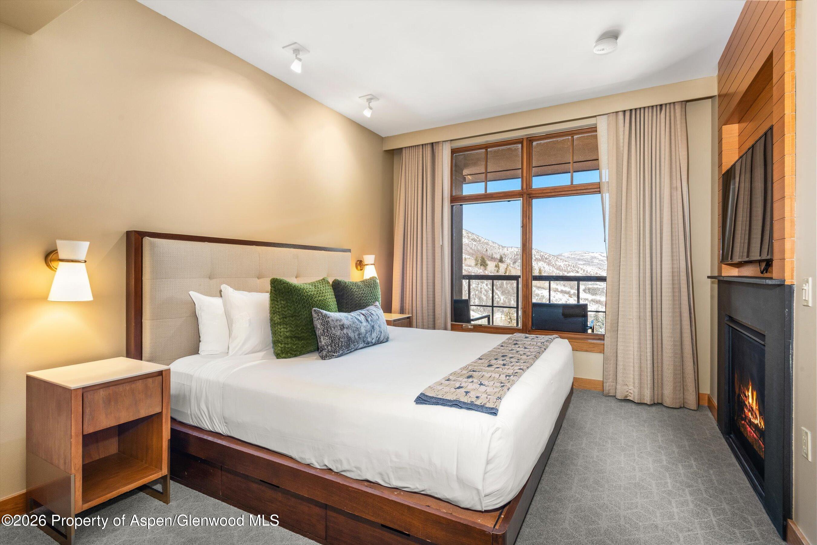 130 Wood Road, Unit 716 Snowmass Village, CO 81615 - Photo 8 of 12 a bedroom with a large bed and a large window