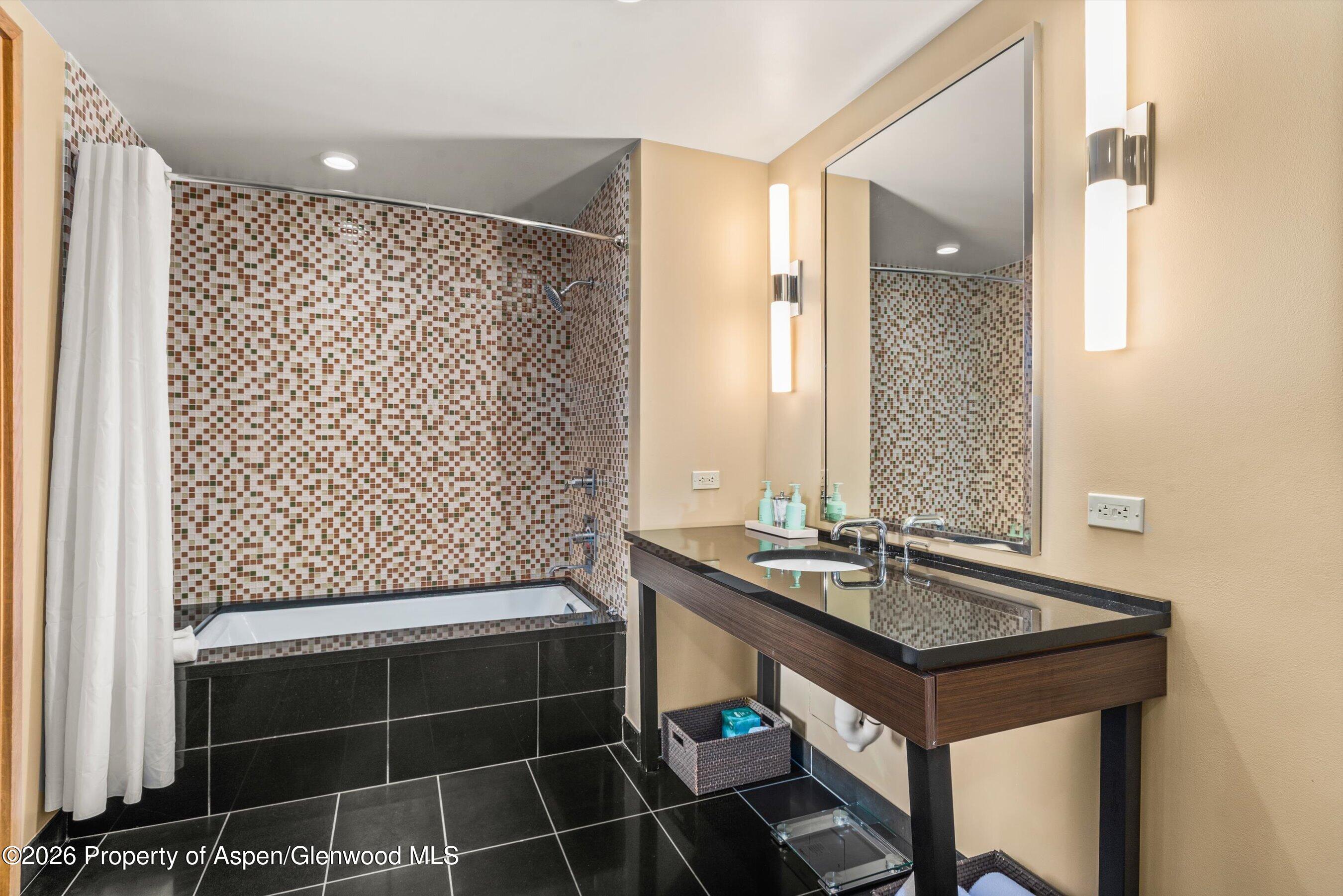 130 Wood Road, Unit 716 Snowmass Village, CO 81615 - Photo 10 of 12 a bathroom with a sink and a mirror