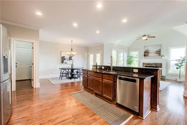 a kitchen with stainless steel appliances granite countertop a stove and a sink