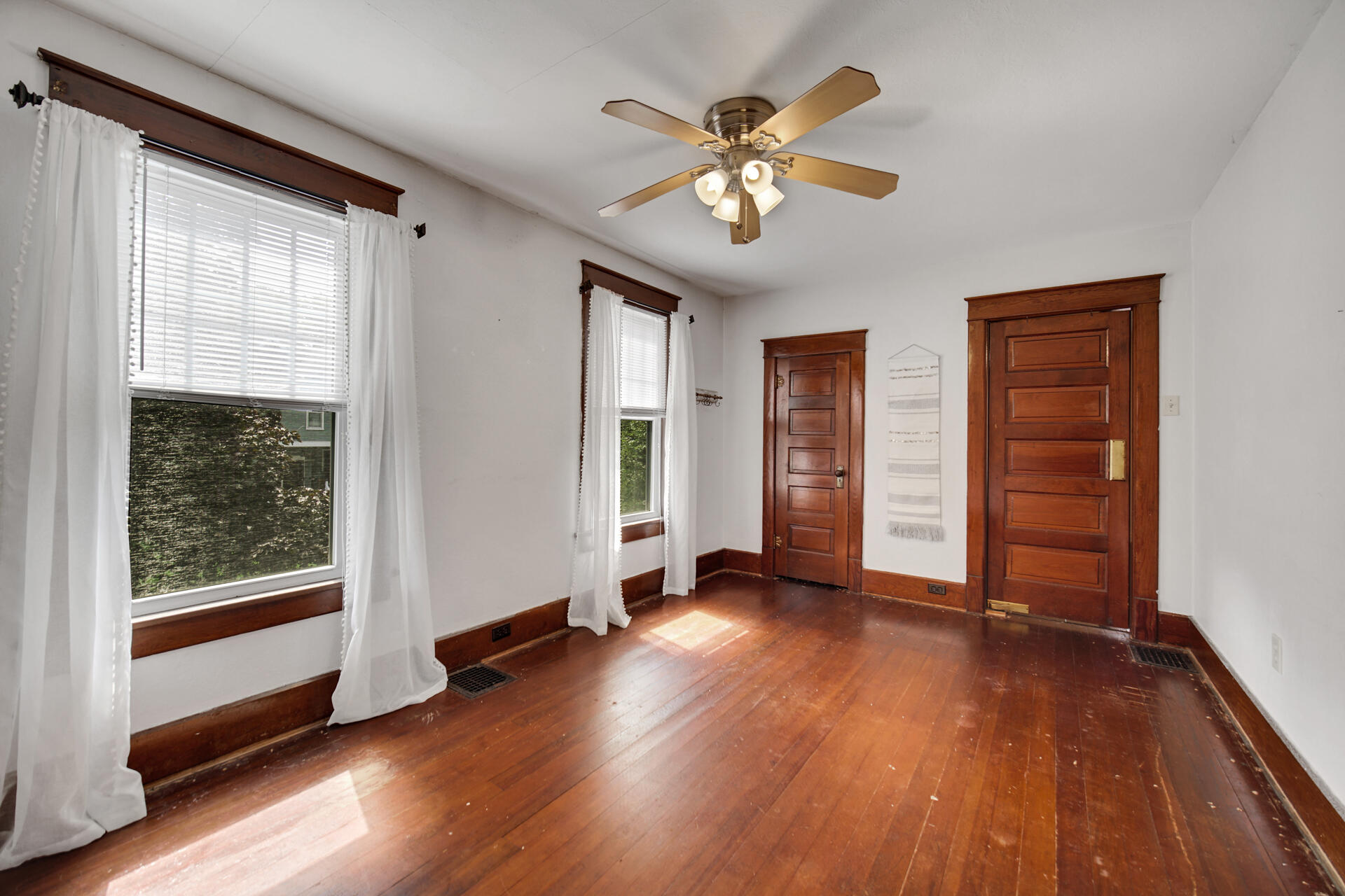 1524 Monroe Street La Porte, IN 46350 - Photo 21 of 32 an empty room with wooden floor closet and windows