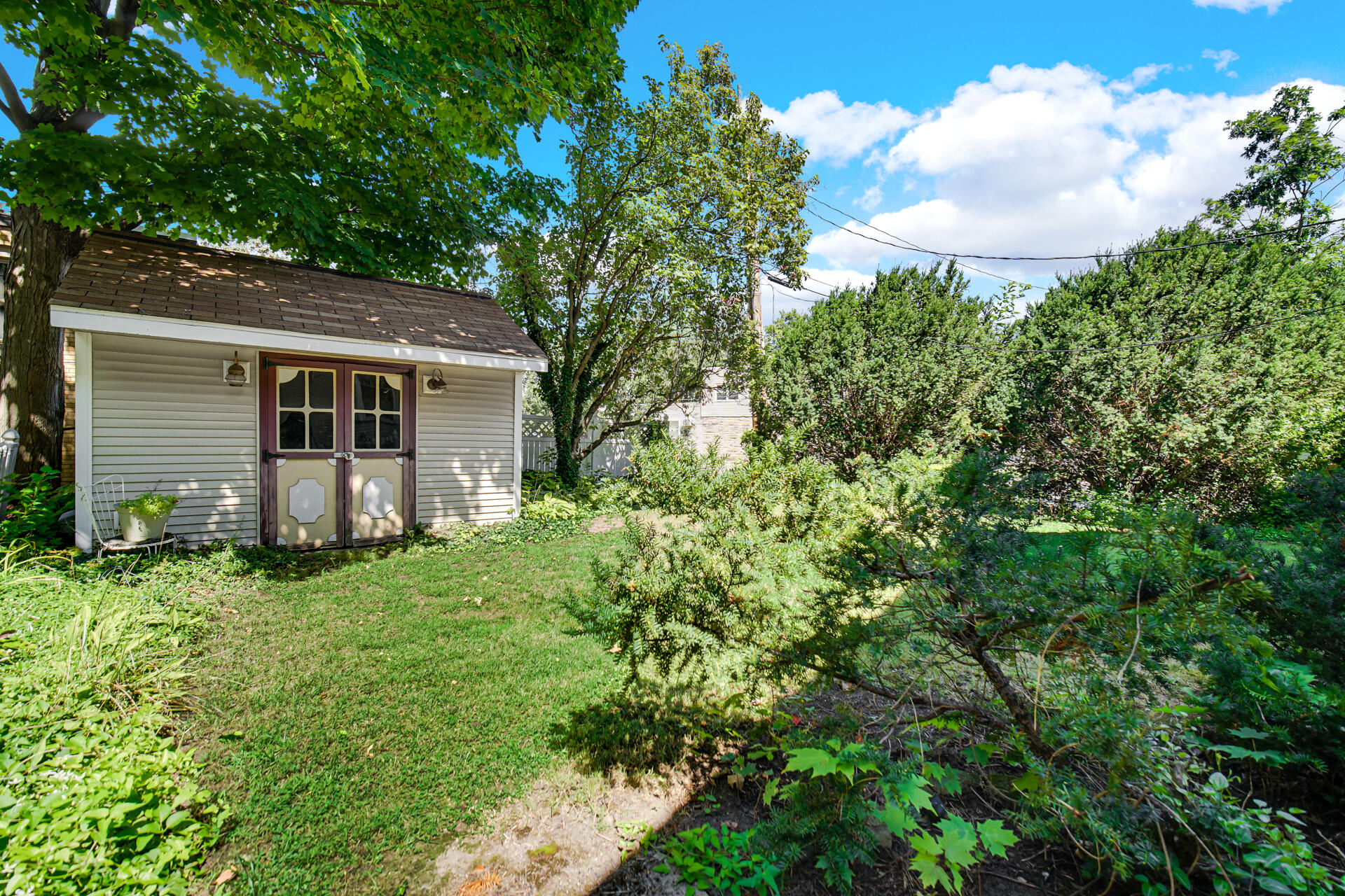 1524 Monroe Street La Porte, IN 46350 - Photo 30 of 32 a backyard of a house with plants and large tree