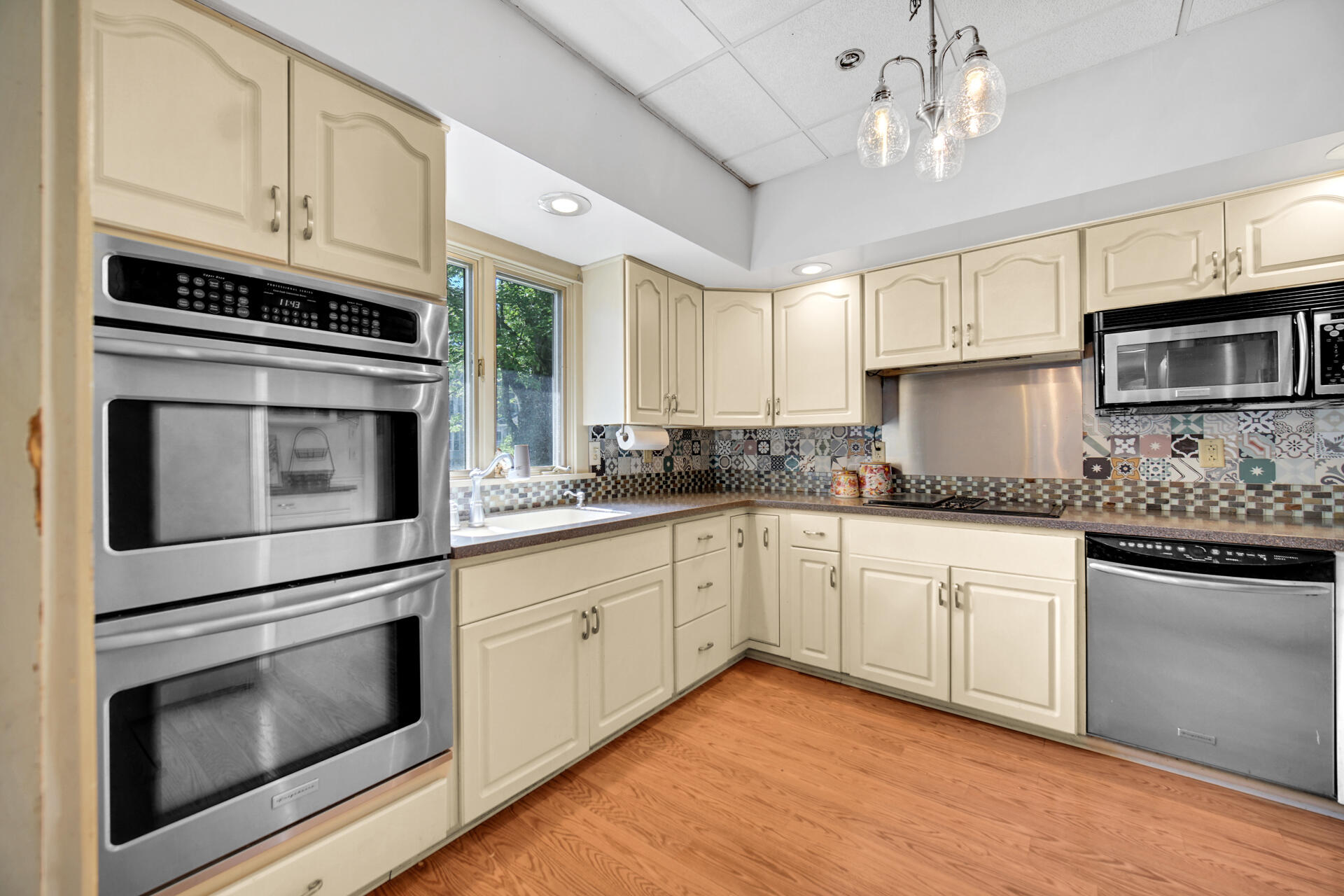 1524 Monroe Street La Porte, IN 46350 - Photo 8 of 32 a kitchen with stainless steel appliances granite countertop a stove microwave and cabinets