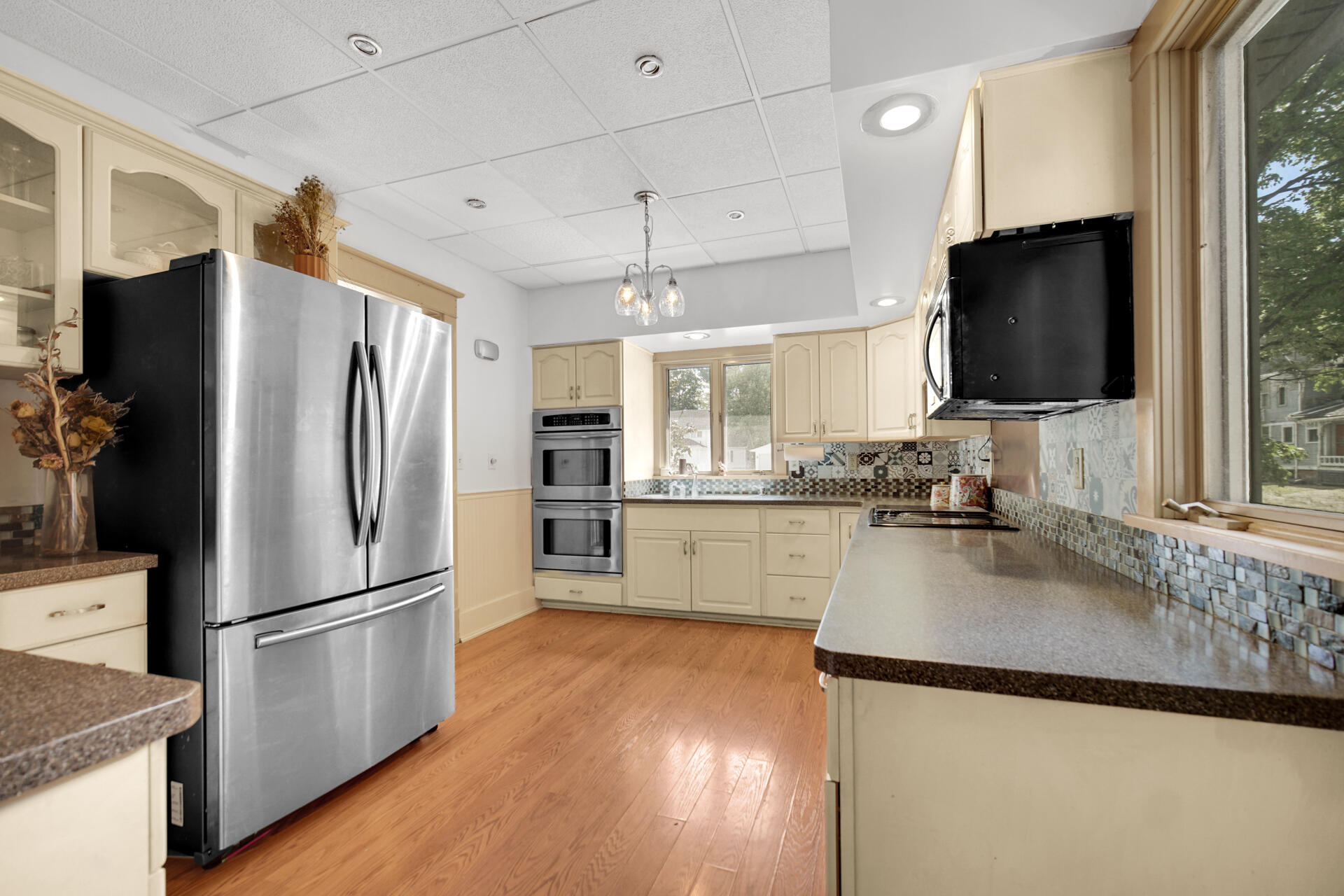1524 Monroe Street La Porte, IN 46350 - Photo 9 of 32 a kitchen with kitchen island a counter top space wooden floor and stainless steel appliances