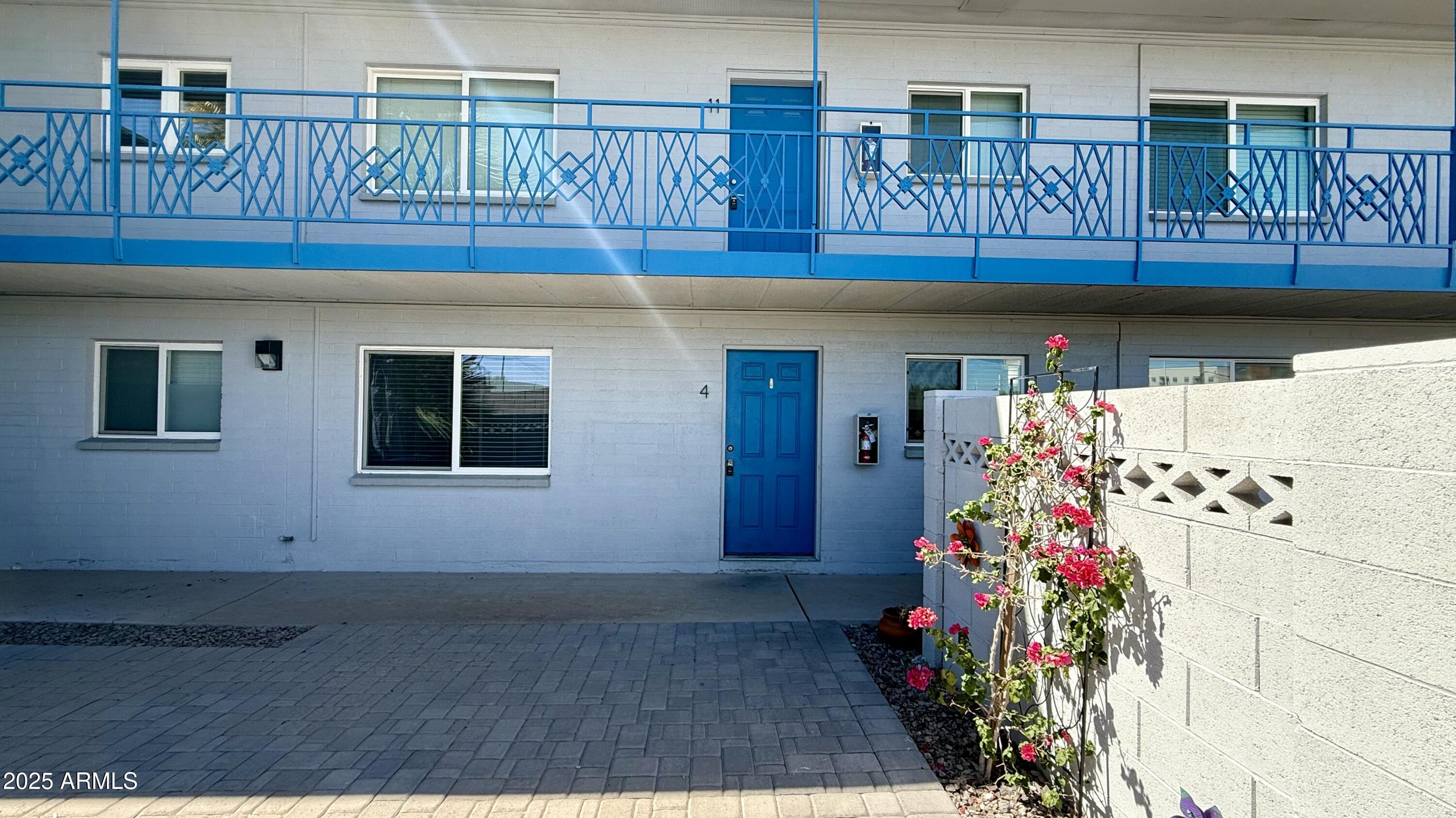 44 East Roanoke Avenue, Unit 4 Phoenix, AZ 85012 - Photo 14 of 19 a kitchen with granite countertop a white cabinets and a potted plant