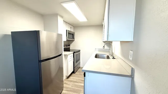 a kitchen with a refrigerator and a sink