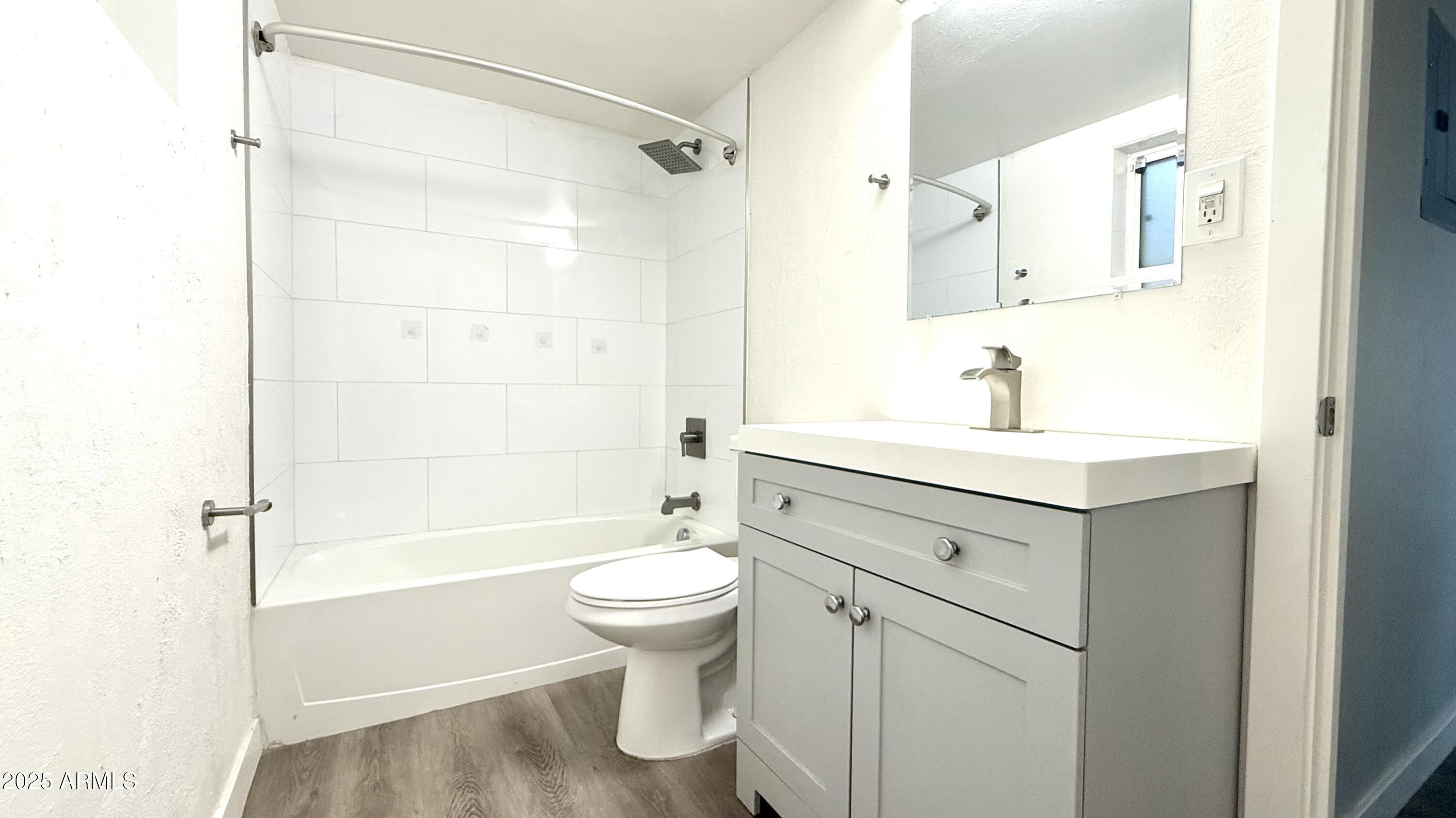 44 East Roanoke Avenue, Unit 4 Phoenix, AZ 85012 - Photo 17 of 19 a bathroom with a sink toilet and shower