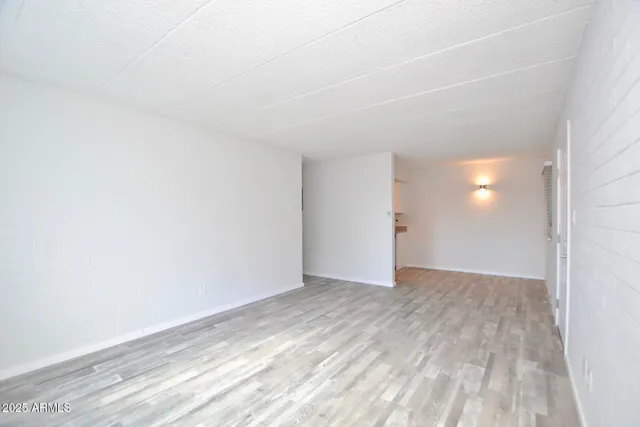 a view of an empty room and wooden floor