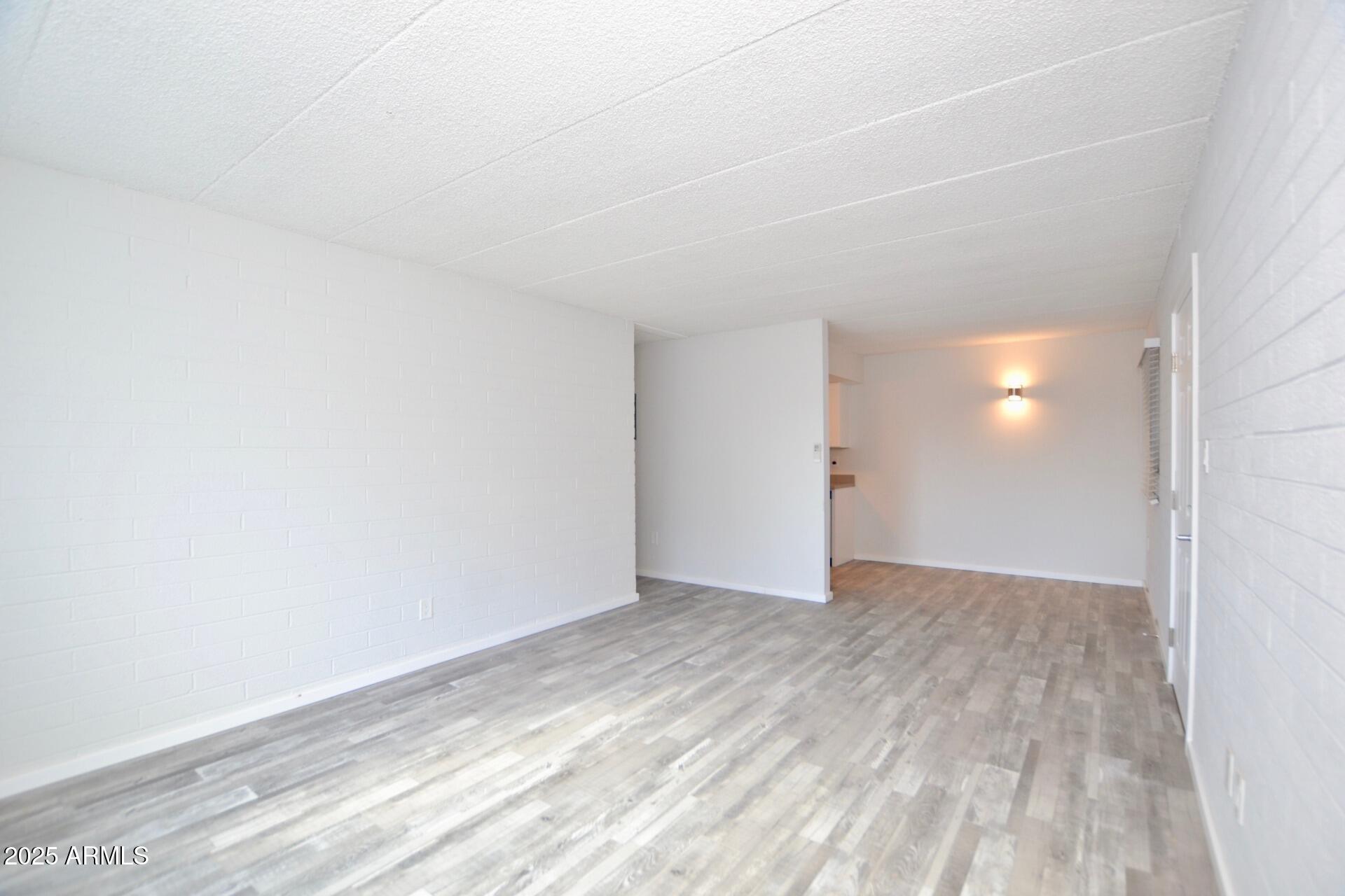 44 East Roanoke Avenue, Unit 4 Phoenix, AZ 85012 - Photo 6 of 19 a view of an empty room and wooden floor
