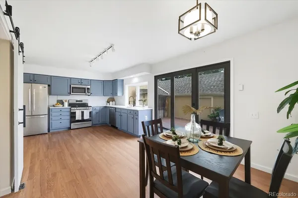 a living room with furniture kitchen view and a refrigerator