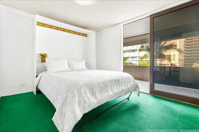 a bed sitting in a room next to a window