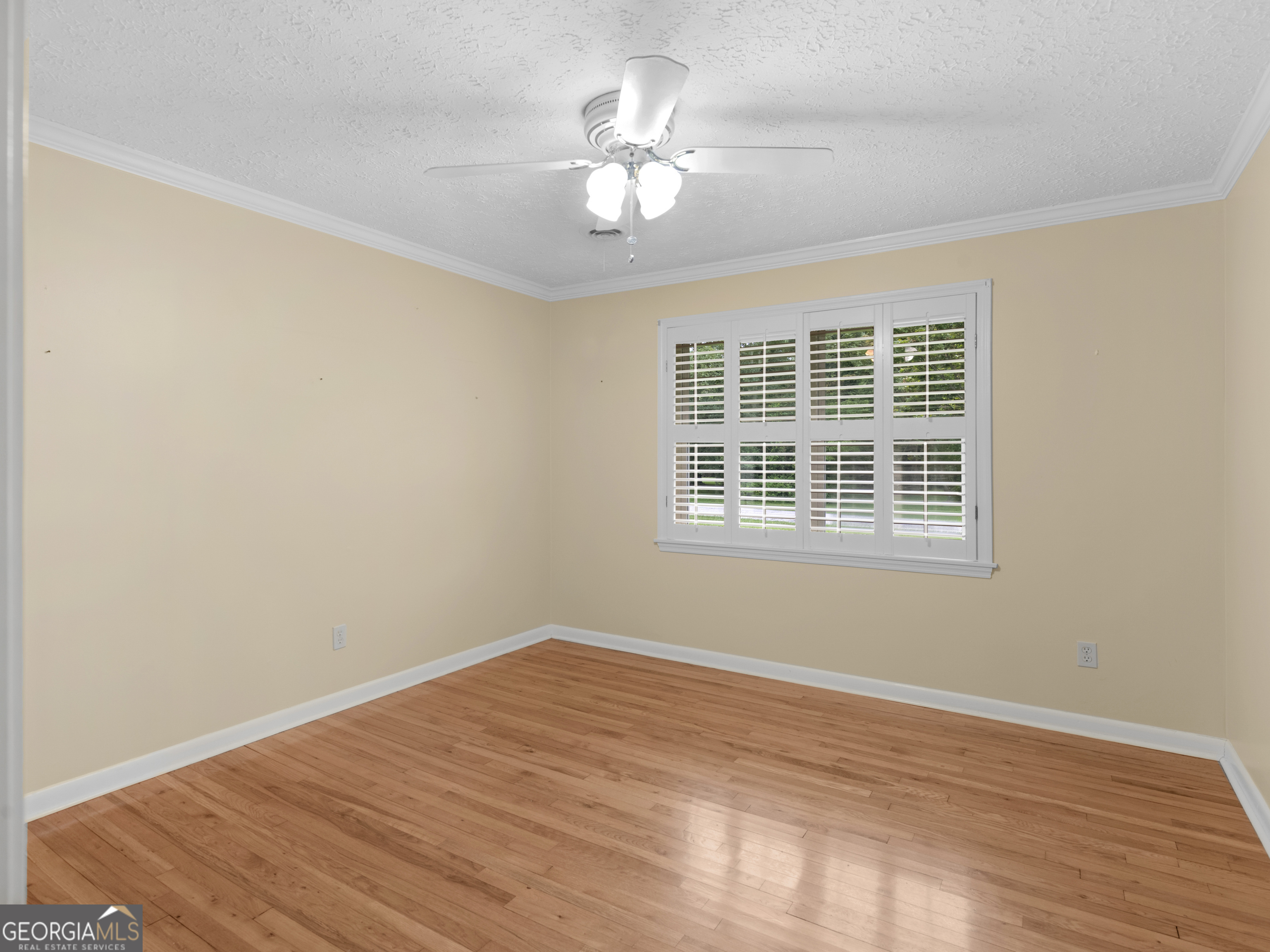 105 Zebulon Street Milner, GA 30257 - Photo 11 of 34 a view of a room with wooden floor and a ceiling fan