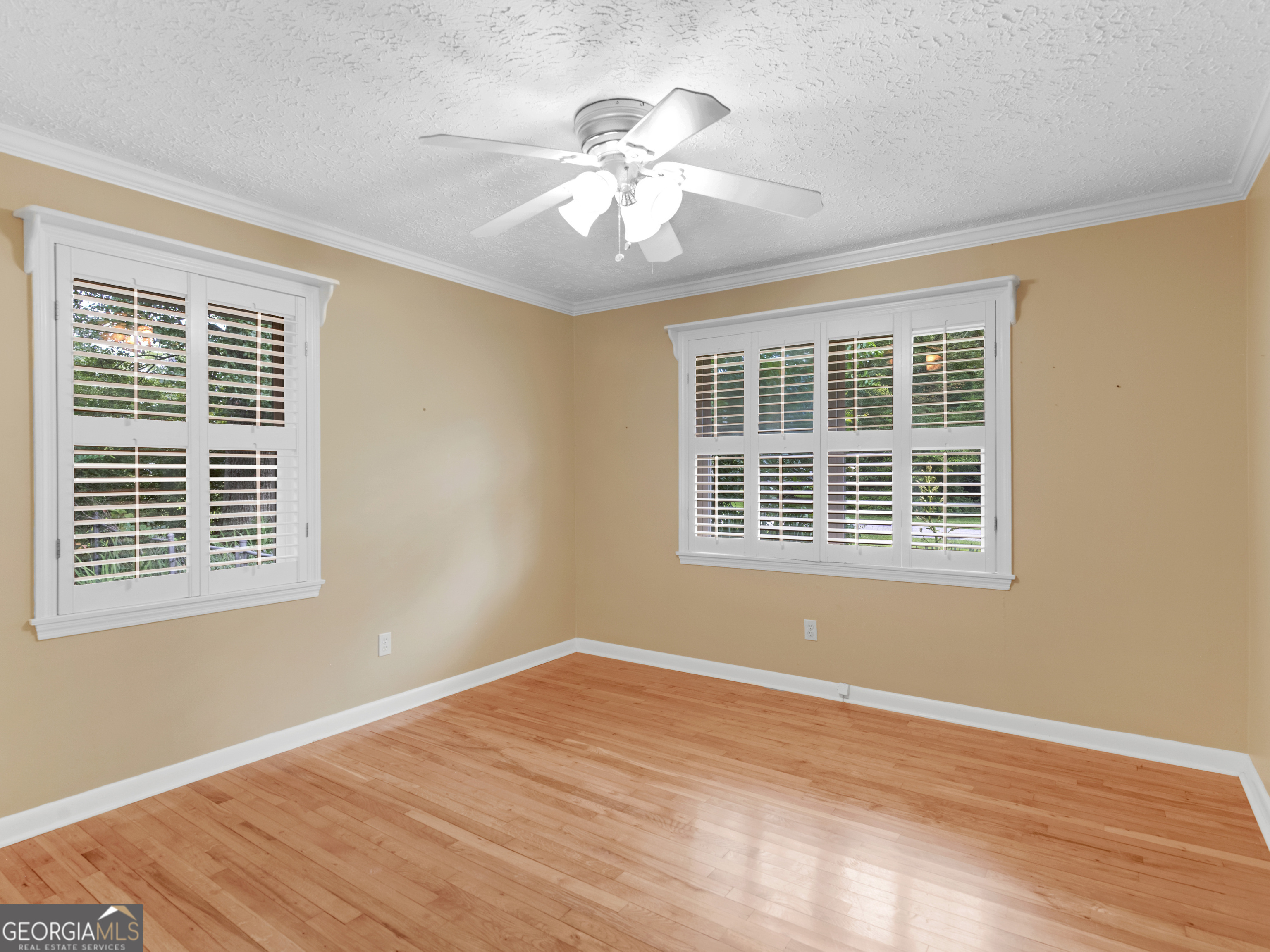 105 Zebulon Street Milner, GA 30257 - Photo 12 of 34 a view of an empty room with wooden floor and a window
